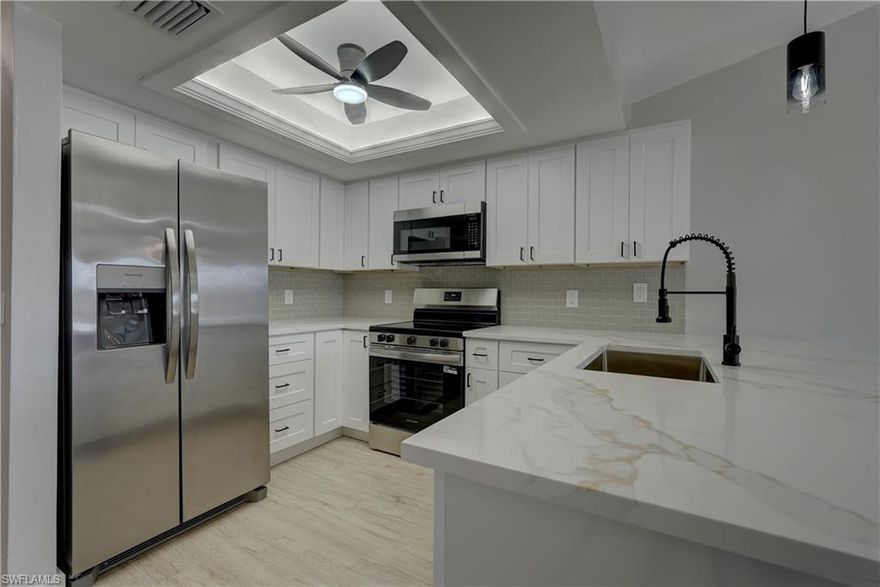 Prepare to be Impressed!!! Gulf Access Waterfront with Pool and under $180,000. Newly updated with matching Tile throughout, even the lanai. New solid wood kitchen cabinets w/soft close doors and drawers and trash pullout, Quartz counters, new stainless appliances, bathrooms w/matching quartz counters and new solid wood vanities, tile showers w/glass doors, new Faucets, new switches and outlets in all rooms. Modern stack washer & dryer enclosed with barn style sliding door. Cathedral ceiling with skylight in living room. New lights and ceiling fans throughout. Newly painted with new modern baseboards. Nautique Condo Association is professional managed and did not flood in past Hurricanes. Lawn service, pool service, water, sewer included in HOA. If you are looking for a great location and nice place to live this is for you.