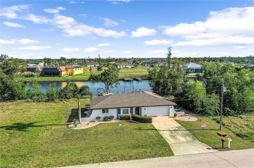 SAILBOAT ACCESS - Move In Ready for $500k! Updated with HUGE Water Views of the 200 foot Lamark Canal! Boating enthusiasts get ready as this home has unrestricted boating access and you can see Lake Laguna from the dock. Upon entering, you'll be greeted by a thoughtfully designed split floorplan, with 3 bedrooms and 2 bathrooms offering both privacy and functionality within its 1539 sqft of living space. Recently installed luxury vinyl plank (LVP) flooring spans throughout the residence, providing durability and elegance in equal measure. The interior is adorned with tasteful decorative wood panel walls and a wood burning fireplace with Coral walls adding a touch of coastal warmth and character to the living spaces. Fresh paint graces both the interior and exterior, rejuvenating the home with a modern aesthetic and enhancing its curb appeal. Kitchen features granite counters and lots of light. Formal dining overlooks the outdoor living space through multiple sliding glass doors. Outside, the allure of unrestricted Gulf access beckons, inviting residents to explore the endless possibilities of waterfront living. There is a large covered Lanai, extended concrete deck, fire pit and walkway to the dock area. The low maintenance composite dock has multiple areas to tie off large vessels and plenty of possibilities to add a lift if you chose. Whether it's boating, fishing, or simply enjoying the breathtaking sunsets, this property offers an unparalleled connection to the natural beauty of its surroundings. PLEASE NOTE: New Roof 2023, New AC 2023, New Well & Septic System, New whole house RO system! 3D tour and features list available! So many upgrades! Call for your private tour today!