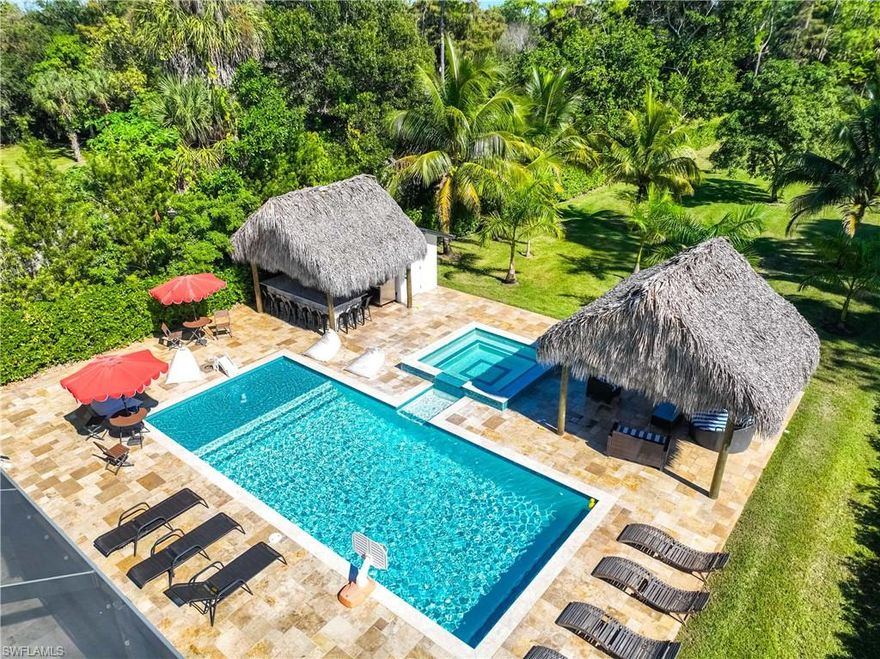 Available September 2026 for long-term or short term rentals! Newly Added, Living room, Two additional bathrooms, pizzeria and fire pit. IMPRESSIVE MODERN PRESTIGIOUS OAKES ESTATE HOME! Private gate with specially made iron fence. It has four bedrooms and is fenced for privacy. Has large brick paver driveway with a turnaround. The driveway walkways are Italian Travitine. The kitchen has white shaker cabinets, custom quartz countertops with brand new appliances. This home features 14 security cameras. Hurricane doors and windows, custom porcelain tile throughout, the outdoor area features a custom bar and entertainment center equipped with all the latest outdoor appliances, grills, refrigeration, cooktops, and prepped areas. It also has Dual television sets with surround stereo. 2 master sinks. Expansive screen enclosure with panoramic view to your luxurious 30,000 gallon swimming POOL with a beautiful hot tub that will seat 12 comfortably. This immaculate 4 bedroom home sits on 1.17 acres with no HOA or restrictions. This can be your tropical paradise and you can build an additional home on the lot. Newer air conditioning unit. 10 minutes drive to the beach, easy access to I-75 and walkable/bike to shopping and dining.