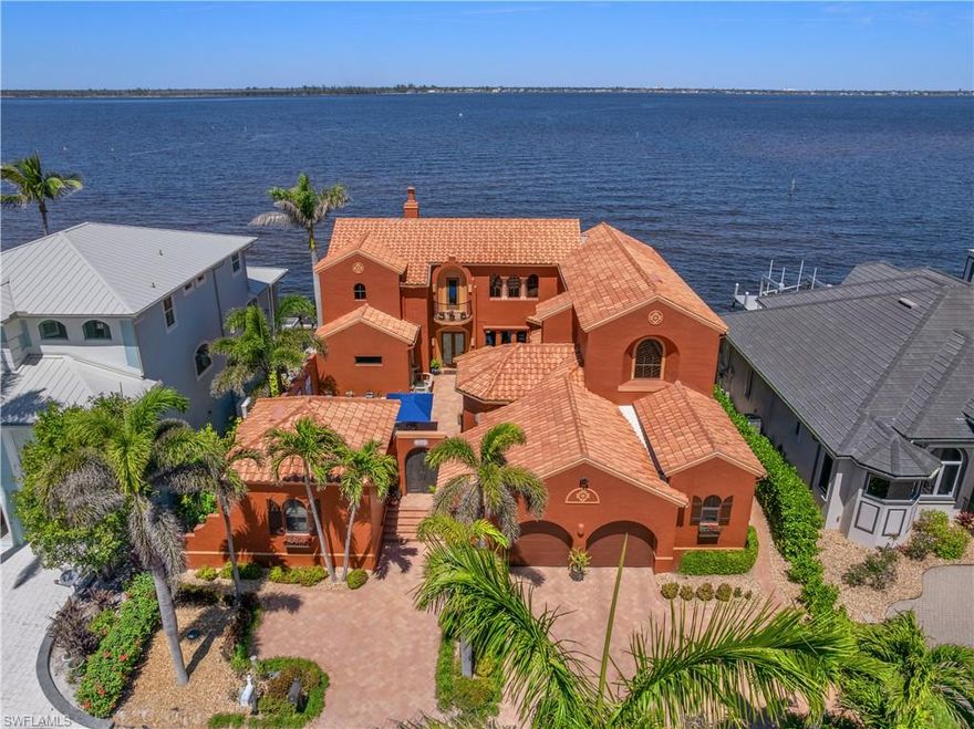 Offered for the first time, this extraordinary custom-built waterfront estate is a rare architectural expression inspired by the timeless beauty and heritage of Santa Fe. Thoughtfully designed by renowned Southwest Florida architect Bud Lawrence and constructed by a highly respected custom home builder, the residence reflects a true labor of love, craftsmanship, and intentional design rarely found in today’s market. Set within a private, gated waterfront community just minutes from Sanibel and Captiva Islands, the home is arranged in a secluded courtyard-style layout with a separate guest casita, creating a resort-like sense of privacy and tranquility. Warm, hand-troweled stucco, classic clay tile roofing, arched entries, decorative ironwork, and rich architectural textures define the exterior, evoking the charm of authentic Santa Fe estates while blending seamlessly into the Southwest Florida coastal environment. At the heart of the home, the private courtyard serves as a central gathering space, complete with a beautifully designed pool and spa, custom tile accents, covered seating areas, and inviting outdoor living spaces ideal for both quiet relaxation and entertaining. Multiple lanais and balconies extend the living experience outdoors, while mature landscaping and palm trees enhance privacy and ambiance.
Inside, the home is a true celebration of Santa Fe craftsmanship. Extensive custom woodwork, exposed beam ceilings, sculpted ceiling details, carved columns, arched openings, and artisan tile accents create layers of character and authenticity that can only be fully appreciated by those who truly value the architectural heritage of the Southwest. Custom built-ins, nichos, and thoughtfully curated finishes add depth and warmth throughout the living spaces.Indoor and outdoor living come together effortlessly, with expansive openings and well-placed glass doors drawing in natural light and framing breathtaking waterfront views from multiple rooms. The home offers multiple gathering areas designed to flow naturally from one space to the next, perfect for everyday living, hosting family and friends, or entertaining on a grand scale. Fireside seating areas, art-filled living rooms, and open entertaining spaces all connect seamlessly to the outdoor courtyards, lanais, and balconies.
Boating enthusiasts will appreciate the home’s prime waterfront setting with quick access to the bay and Gulf of Mexico, offering world-class fishing, island hopping, and waterfront dining by boat. This is a one-of-a-kind opportunity to own a custom architectural residence where Santa Fe soul, Southwest Florida lifestyle, and waterfront living come together in perfect harmony