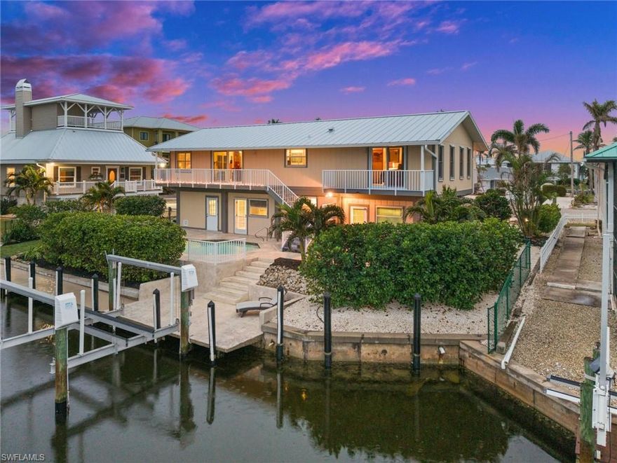 This waterfront gem has been lovingly cared for, with every detail reflecting the pride of ownership and meticulous attention to maintenance. Direct, deep-water Gulf access pool home, perfectly positioned just minutes from Pine Island Sound and the Intracoastal Waterway. Offering easy access to backwater fishing and the pristine beaches of Sanibel, Captiva, Cayo Costa, and Boca Grande, this is a true boater's paradise. The home boasts 105 feet of prime waterfront and a 10,000-pound boat lift, making it ideal for those who live for the water. This unique property features a dual-living design—two homes in one. The first level offers complete privacy with an en suite bedroom, kitchenette, remolded full bath with walk-in shower. The second level is equally impressive, featuring two spacious bedrooms, a well-appointed remodeled bathroom, a great room with hardwood and marble flooring throughout and a gourmet kitchen equipped with newer Kitchen Aide Signature stainless steel appliances, convection oven, and sleek granite countertops. Whether you’re relaxing inside or enjoying the spectacular water views, your private balconies will be your sanctuary. Property Updates include: 10K Boat lift with new motors, PVC plumbing throughout, AC 2023, Water Heater 2023, Electric Panel 2023, Standing Seam Metal Roof 2023, Aluminum Railing on all Balconies, Impact windows and doors on 2nd level and new impact garage doors and entry doors all levels, so many more improvements please see attached list. Located in the heart of St. James City, this home is the ideal retreat for water enthusiasts and outdoor lovers. Spend your days kayaking, fishing, or boating to local restaurants. And for those looking to explore the best fishing waters in the world, it’s all just minutes away. Whether you're out on the water or enjoying the peaceful serenity of your private retreat, this home is where memories are made. Don’t miss your chance to live the ultimate island life—schedule a showing today!