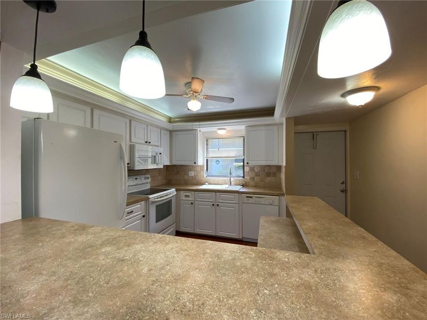 Welcome to your own slice of Paradise in Bonita Springs located on the 1st floor condo in Pine Haven! This two bedroom, 2 bath condo comes complete with your own Carport and Extra storage! Kitchen boasts updated cabinets and counters along with Spanish tiles flowing into the living area. Bedrooms offer recently done vinyl wood flooring, AC was replaced in 2021 and Washer/Dryer only 3 years ago. Community offers Gated access, Heated Community Pool, PICKLEBALL, Tennis, Library, Free Wi-Fi at the club house, FISHING, and lush land landscapes.