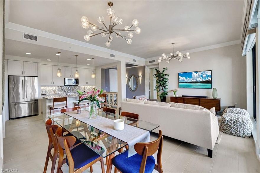 Experience luxury downtown living in this immaculate, turnkey-furnished Penthouse in Naples Square’s coveted Design District. The home features a soft neutral palette, sophisticated tile flooring that extends to the lanai, contemporary lighting, motorized shades, and plantation shutters. Design upgrades include a custom étagère, quartz countertops, custom closet systems, and added built-in storage.

The serene lanai overlooks a lush tropical courtyard—perfect for quiet relaxation. Naples Square residents enjoy resort-style amenities: a pool, spa, fire pit, grilling and dining areas, and a covered outdoor bar. All just steps from 5th Avenue dining and boutiques, Bayfront, the AC Marriott’s Limon Rooftop Bar, and the new Gulfshore Playhouse. Pet-friendly luxury at its best.