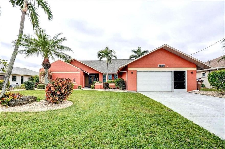This beautifully maintained & remodeled Gulf Access Pool Home is a MUST see! Step through the double door entry into a bright, with natural light and a stunning view of the lanai, pool, and wide Gulf access canal. The main living area and primary suite feature sliding doors that, seamlessly blending indoor and outdoor living—perfect for entertaining and enhancing your Florida lifestyle. This home offers 3 bedrooms, 2 full bathrooms, and a den. The island kitchen is a chef's delight, with granite countertops, wood cabinets, and an eat-in island—ideal for gatherings. Stainless steel appliances complete the space, ready to inspire your inner chef. The sliding glass doors lead to the spacious lanai, where you can relax or entertain pool side. Enjoy the electric-heated pool that has been resurfaced with pebble tech finish or simply take in the serene water views. The remodeled Primary suite features sliding glass doors to the lanai, wood look tile flooring, mini split AC, an ample California closet designed for max storage & organization, Modern barn doors open to the ensuite that was designed inspired by the perfect Spa Day and features dual vanities, both a soaking tub overlooking the perfect atrium and frameless glass shower with custom glass mosaic tile. The guest bathroom has been remodeled & conveniently doubles as a pool bath. Recent upgrades include a new roof (2023), rescreened pool enclosure, 6" gutters around the home, new decking on the Captain's Walk Dock & 7k lbs. boat lift. Roll down Kevlar hurricane shutters were added to protect the entire lanai and offer maximum protection. Boating enthusiasts will love the captains walk and boat lift right in the back yard, while only a short 20-minute ride to the river, offering easy access to the Gulf of Mexico. Centrally located near retail, major roads, hospitals, and Fort Myers, this home is in a peaceful area yet close to everything. Has City Water and Sewer in and paid and located in flood Zone X, so no flood insurance required. This property is definitely worth your time and consideration! List of upgrades are included in the supplements in the MLS.