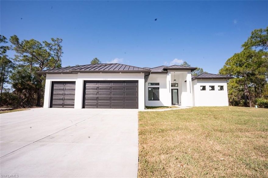 Beautiful new construction home on a quiet dead-end street in Lehigh Acres. Featuring high ceilings, open-concept layout, impact windows and doors, and durable aluminum roof. Spacious 3-car garage and sitting on a half-acre lot with plenty of room for outdoor living. Great location near main roads, shopping, and schools.