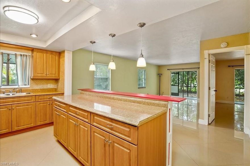 This private and secluded ground-floor residence is a rare find. Step inside to an updated kitchen boasting a granite island and sleek stainless steel appliances, all complemented by durable glazed tile flooring that flows throughout. The in-unit laundry adds convenience to daily life. A screened patio offers a quiet space to enjoy your private backyard view. This property provides a fantastic opportunity to add your personal touch and build equity.