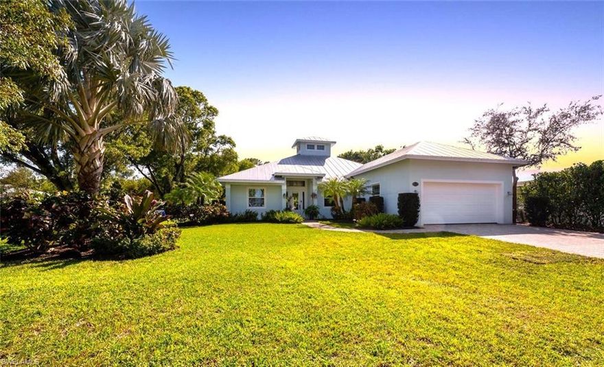 LAKE PARK BEAUTY!  Lake Park is the hidden gem of Naples.  Live in the middle of everything!  Walk to the Greenway, shops and restaurants, Fleischmann Park, and award winning Lake Park Elementary, bike to the beach and 5th Avenue South!  A home like this hasn't been on the market in Lake Park in a long time.  Huge open floorplan with high ceilings and a 26' high copula, pocketing hurricane rated sliders opening to the private backyard and pool.  The kitchen has an enormous island with room for everyone to congregate.  Unbelievable master suite with coffered ceilings featuring gorgeous wood beams, his and hers walk-in closets, claw foot tub, walk-in shower, and a separate access to the pool area. Then, there is the garage- 33' deep and 22' wide with 12' high ceilings, tiled floor, built in air compressor and hoses, and room for 2 cars plus all your toys!  The beautiful and enormous 12,632 sq. ft. corner lot is a show piece and expertly manicured.  The irrigation is connected to a grandfathered well with an iron treatment system to eliminate the orange staining, and you never have to pay for watering your lawn again!