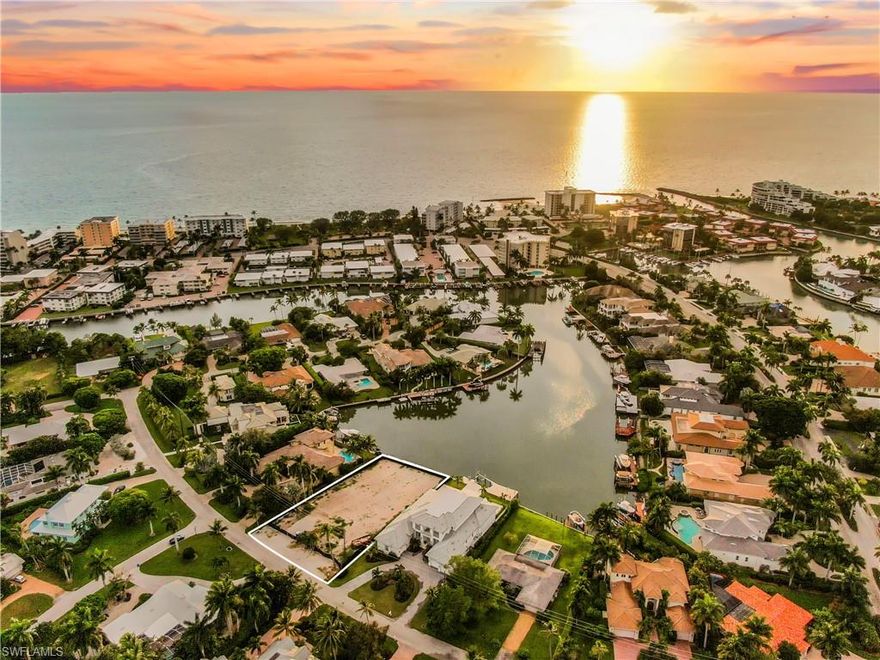 The Moorings. This is a once in a lifetime opportunity that will allow you to live the Florida lifestyle on one of the most desired properties in the Moorings. LARGEST WATERFRONT LOT  | 0.44 ACRES | OVER 100 FEET WATERFRONTAGE | STUNNING AND WIDE OPEN BAY VIEWS | WESTERN EXPOSURE | AMAZING SUNSETS. This quiet street is perfect for BUILDING THAT NEW DREAM HOME, where newer construction sells for over $7M plus. Only 899 steps to the beautiful white sandy Moorings Private Beach. Depart for the Gulf of Mexico from your private dock and enjoy nearby upscale dining and shops at Venetian Village, Waterside Shops, or Downtown Naples.A great opportunity to build your dream home, renderings available.