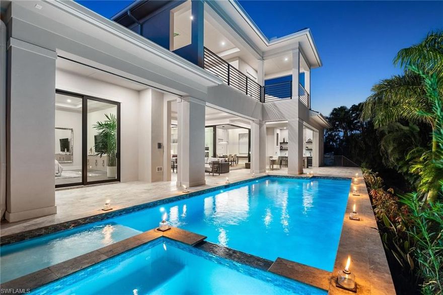 Contemporary coastal architecture with clean, modern lines is thoughtfully softened by transitional details in this stunning four-bedroom, four-and-a-half-bath Moorings residence. A striking entry through glass double doors reveals soaring ceilings, custom wood flooring, and a chic wet bar with wine storage—setting the tone for refined yet relaxed living. 

Built with quality and longevity in mind, the home features a full concrete, elevated structure, a galvanized steel tile roof, planned space for a whole-home generator, and high-end interior finishes throughout. The gourmet kitchen is a true showpiece, showcasing Sub-Zero refrigeration, Wolf cooking appliances, waterfall quartz countertops, and custom walnut cabinetry, all beautifully complemented by designer ceiling details. 

The thoughtfully designed floor plan allows for effortless entertaining, seamlessly blending indoor and outdoor living. Pocketing 8-foot sliders open to the expansive lanai with electric roll-down screens, a full summer kitchen, and a cozy outdoor fireplace—perfect for creating ambiance day or night. 

The owner’s retreat is a private sanctuary, offering a separate sitting area with direct lanai access, dual walk-in closets, and a spa-like bath. Family and guests will appreciate the upstairs living area, complete with a great room and wet bar, plus an oversized covered balcony ideal for gathering and relaxation. 

Ideally situated in the desirable north end of the Moorings, this exceptional home places you just a short golf cart ride from private Moorings beach access and the shopping and dining of Venetian Village—an ideal setting for your Naples lifestyle.