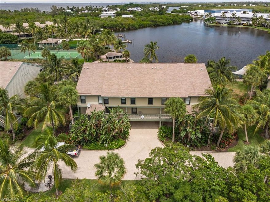 The Premier "Corner Unit".. with Bay front views of Jug Creek at THE BOCILLA ISLAND CLUB!! Bocilla Island Club is more of a beautiful Resort than a Condominium... Incredible tropical landscaping that rivals Hawaii or Islands of the Caribbean.. Townhouse style with master bedroom, bath and porch with waterfront views, utility room and second bedroom on the top floor... Kitchen, Living area (with waterfront two side views !), 1/2 bath and screened porch all with waterfront views...Also DOCK &  NEW LIFT come with this property !!!   Two Beautiful pools, tennis courts, Pier to Charlotte Harbor, docks on the canals leading to Jug Creek & Ship Store... take a look at the photos... Enjoy the relaxation, views, swimming, tennis, boating, a 16 mile bike path( one way) and some of the best boating/fishing anywhere in the world!!!!!