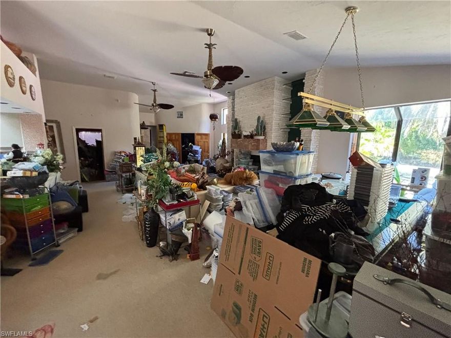 Discover this expansive estate in the exclusive Brynwood community, set on over 2.5 acres. This residence features a versatile floor plan with five bedrooms plus an office easily serving as a sixth. The interior showcases marble and carpet flooring, a stainless steel appliance package, and a 3-car garage with a climate-controlled stall. A six-year-old roof provides peace of mind above this solid structure. Ready for your creative vision, this property offers a premier opportunity to customize a significant space in a prime South Fort Myers location.