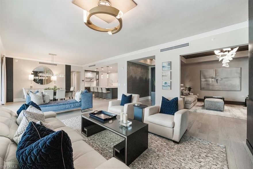 Absolutely stunning, exquisitely upgraded, elegantly furnished home at the Quattro at Naples Square!  Every detail was thoughtfully and exceptionally executed to transform this condominium into a luxurious and sophisticated oasis.  Designed with every lifestyle in mind, the Bianca has more space than any other floorplan at Naples Square with an expansive great room, a lounge area, a gourmet kitchen, and a large balcony along with 4 generous bedrooms, each with an ensuite bathroom.  Throughout the entire unit, you'll find hardwood flooring, statement making light fixtures, beautiful and functional window treatments, and unique designer flourishes, such as the custom built-ins and fireplaces in both the great room and lounge.  The kitchen is equally poised as an entertainment hub and chef's workspace with top-of-the-line equipment, by Wolf, Miele and SubZero.  Whether hosting guests or having an intimate night with family, the options for dining and relaxing in the kitchen, great room with formal dining or on the balcony are endless - with the option of creating a seamless transition with fully pocketing sliding doors.  When it's time to retreat to the bedrooms, the primary is the ultimate sanctuary featuring a luxurious spa bathroom with dual vanities, a luxurious rain shower, a Jacuzzi soaker tub, and two walk-in closets with deluxe storage systems. The adjacent guest suite is an excellent option for a home office with access to the balcony. The two larger guest suites are on the opposite side of the home to afford flexibility and privacy, and both have large walk-in closets, upgraded bathrooms, and access to either the shared balcony or a Juliet balcony. Included are two garage parking spaces, a storage unit, and access to all of the amenities of the Quattro building and Naples Square.  Perfectly located in the Naples Design District just minutes from vibrant 5th Ave S, this home's access to art, design, style, food, beaches, parks and culture is truly beyond compare.