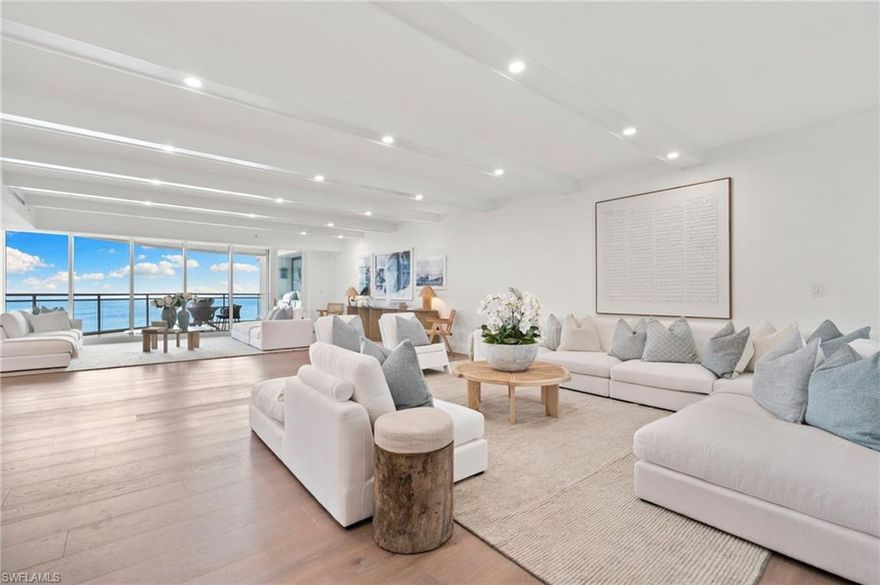 Impressively presented and professionally decorated in an organic modern style, this extraordinary penthouse at Moraya Bay offers refined coastal living at one of Naples’ most prestigious beachfront addresses on Vanderbilt Beach. Spanning approximately 4,548 square feet, the residence features 9-foot ceilings, a grand salon, formal dining room, and a spacious family room, all oriented to capture commanding Gulf views through expansive walls of floor-to-ceiling glass. The thoughtfully curated interiors blend clean architectural lines with natural textures and soft neutral tones, creating a warm, sophisticated, and timeless organic modern aesthetic. Wraparound balconies and expansive terraces extend the living spaces outdoors, allowing for seamless indoor-outdoor living and multiple settings to relax, entertain, and enjoy breathtaking sunsets over the Gulf. The primary suite boasts Gulf views and a spa-like ambiance, while additional guest suites are generously sized and well-appointed for comfort and privacy. A private, air-conditioned two-car garage—a rare and highly desirable feature in high-rise living—adds to the residence’s exclusivity and convenience. Located directly on Vanderbilt Beach, Moraya Bay is a pet-friendly, five-star community offering exceptional amenities, including a gourmet beachfront restaurant and bar, two resort-style pools, concierge services, chair and towel service, a state-of-the-art fitness center, and 24-hour security. Residents also enjoy a gated entrance, 24-hour doorman, and private elevator access, ensuring a secure and discreet living environment. This remarkable penthouse delivers a rare combination of scale, presentation, lifestyle, and beachfront prestige—offering immediate enjoyment in a beautifully styled organic modern coastal residence.