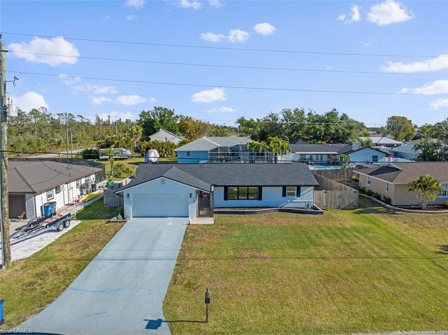 What an ADORABLE property with GULF ACCESS BOAT RAMP IN THE COMMUNITY! THIS is the Florida winter getaway or the family home you have been dreaming of! *** Assumable VA Loan at 2.75% may be available for certain qualified Buyers (Please Inquire). This 3 Bedroom 2 Bathroom property with 2 car garage and fully FENCED YARD has been completely redone from top to bottom, and is MOVE-IN-READY! Located in Island Park Woodlands, this property West of 41 has so much to offer with a PRIME location! Some of the incredible features/upgrades include Remodeled kitchen with Stainless Appliances and Remodeled Bathrooms, Tile Throughout (NO CARPET), NEW Roof, AC and Water Heater in 2023, ALL wiring completely replaced in 2023, 200 Amp GE Panel, Whole home surge protector, Portable Generator interconnect, and 30 Amp RV plug. NEWER 6Ft wooden fence with a 4 1/2 ft gate and 10 ft gate for boat/camper parking. Lockable storage room on the side of the home is also a GREAT additional feature. The backyard and lanai are private and perfect for relaxing on your days off. This great location offers a GULF ACCESS Boat Ramp, Kayak Ramp, Tennis/Pickleball Court, Playground and lots of great community activities for ONLY $240 YEAR!! QUICK ACCESS TO SW Florida International Airport, Lots of Restaurants, Shopping, and the beautiful SW Florida Beaches! Schedule your showing TODAY!