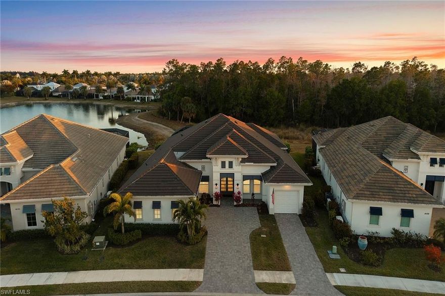 From the moment you arrive, this 2022 Stock Development Livia II residence reveals itself as a home designed for both beauty and ease. Set against tranquil lake and preserve views with coveted southern exposure, the setting feels private, serene, and effortlessly elegant.
Inside, over 3,000 square feet of thoughtfully curated living space unfolds with a natural flow. Engineered hardwood floors lead you through the open great room, where modern ceiling beams and recessed lighting create architectural interest without overpowering the calm sophistication of the home. Entertaining feels intuitive here—enhanced by a custom wet bar with wine refrigeration, seamlessly connecting gathering spaces for both intimate evenings and larger celebrations.
The kitchen is as functional as it is refined, designed for those who appreciate both craftsmanship and performance. Quartz countertops, a stainless farmhouse sink, hidden island cabinetry, soft-close drawers, and under-cabinet lighting are complemented by a premium KitchenAid appliance suite with gas cooking and wall ovens—making everyday meals and special occasions equally inspired.
The primary suite offers a peaceful retreat, opening to the lanai and filled with soft natural light from transom windows. Dual walk-in closets and a spa-like bath complete the experience, featuring dual vanities, a soaking tub, and an expansive walk-in shower with multiple showerheads and frameless glass. Each guest bath continues the home’s elevated design with custom tilework, tile-to-ceiling finishes, and refined fixtures.
A flexible den with glass French doors and a custom Murphy bed provides versatility—ideal as a private office, media room, or welcoming guest space.
Outdoors, the home truly shines. The heated saltwater pool and spa with sunshelf, deck jets, and clear-view screen enclosure invite year-round enjoyment, while the gas fireplace and fully equipped outdoor kitchen—complete with Vintage grill, Zephyr vent, refrigeration, and custom cabinetry—set the stage for evenings under the stars.
Behind the scenes, every detail has been thoughtfully considered, including impact windows and doors, a whole-house Generac generator, buried propane tank, dual Trane HVAC systems, tankless water heater, Sonos sound system, plantation shutters, custom closets, landscape lighting, and an epoxy-finished three-car garage with storage and attic access.
Located within Naples Reserve, this residence offers not only a beautifully crafted home, but a lifestyle defined by connection, comfort, and understated luxury.