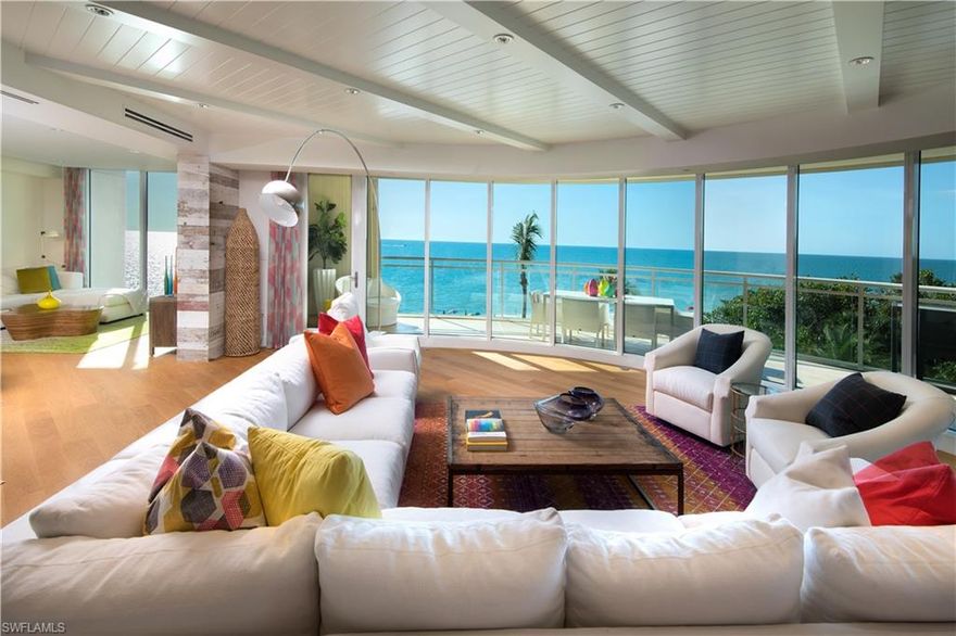 Rarely available "06" unit offers a panoramic view through walls of glass. It is an entertainer's dream in the luxurious award-winning Moraya Bay. This perfect beachfront location sits directly on Vanderbilt Beach, offering an enormous wraparound terrace with unobstructed views of the beach, luxury pool & aqua waters of the Gulf.  Designed by esteemed Renee Gaddis Interiors. Private elevator drops you directly into the home through the 200 yr old live edge custom Cypress entry doors. Hardwood floors throughout, Simon Pearce light fixtures and reclaimed wood accent walls show off the space, along with kids custom bunk room. Incredible Views from the "never been used" kitchen complete with Madreperola quartzite waterfall countertops, 2 dishwashers, gas cooktop, dual ovens, 2 refrigerators, large butlers pantry, make entertaining a breeze.  Large mstr bath is a spa retreat with dual vanities, 2 water closets, & spa tub.  Guests enjoy private access to their own en-suite bedrooms.  24-hour security, onsite concierge with full-service beach club, restaurant, grotto bar make this your home within a five-star pet-friendly resort.