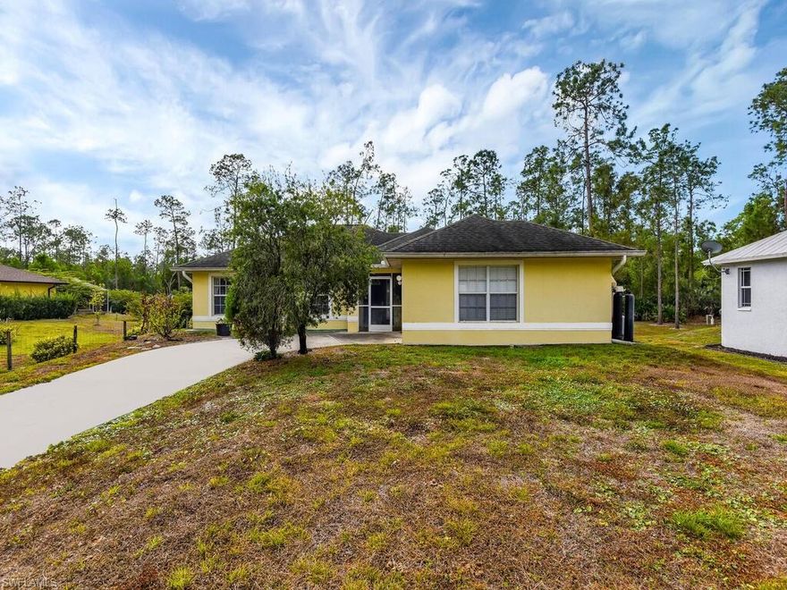This home is located on over an acre of beautiful land to enjoy the peace and quiet. The open concept floor plan with cathedral ceilings makes you feel right at home!! The lanai is a great spot for your morning coffee to enjoy your peaceful back yard with plenty of room to add a pool. The garage is currently being used as a work out room and is also where the washer and dryer are located. It can easily be converted back to a garage. There is also a carport and shed located on the right side of the driveway.