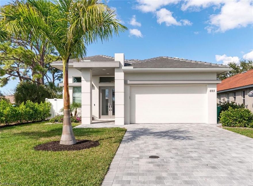 This upscale home will impress you from the moment you pull up the driveway on a beautifully landscaped north facing lot. This home was built in 2020 and is less than 15 months old for worry free living. This custom pool home offers 4 bedrooms and 3 full baths with an open floor plan, 10' ceilings, custom tile throughout, modern look throughout. Gorgeous gourmet kitchen with stainless steel appliances, Quartz countertops, glass tile backsplash and upgraded cabinets. The primary bedroom offers 2 walk-in closets, large vanity with Quartz countertops and spacious shower with frameless enclosure and custom tile work. The pool offers a sun shelf with water feature, outdoor shower, extended patio and landscaping that will enhance your enjoyment of the lanai and outdoor wet bar. The home also features impact glass on all windows and doors, stucco soffits and overhangs, epoxy garage flooring and private PVC fenced yard. All of this and only a short bike ride to the beautiful beaches of the Gulf of Mexico and the Mercato, which offers a variety of dining and shopping experiences.