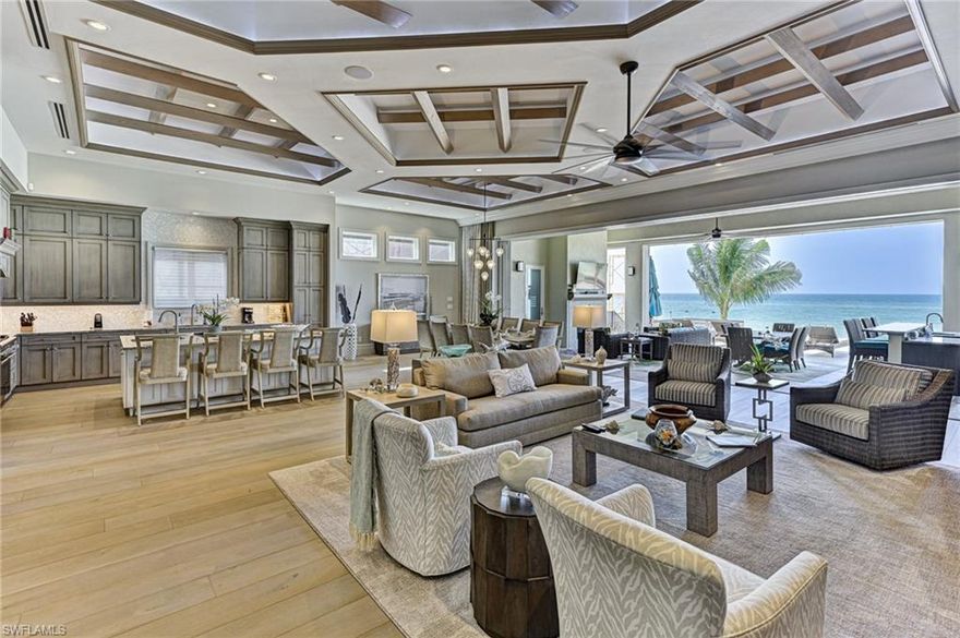 This Bonita Beach front home is not your typical spec property but a Damon Custom Structures custom built one owner house with every conceivable upgrade & design feature imaginable plus a floorplan that captures the Gulf views and sunsets from nearly everywhere in the home.  With 5633 square feet of air conditioned space and 10,637 square feet of total living area this grand home offers 5 bedrooms, 7 bathrooms, a flex room/6th bedroom/cloud room, office and large open indoor and outdoor living areas. The main living level’s great room, Chef’s kitchen, dining room and large sit at bar with glass chilled wine room all open via a wall of glass sliders to the 40’ covered lanai, and negative edge swimming pool & spa with oversized open sun deck area around the pool - all with wide views of the turquoise water and ever changing sunsets.  The kitchen with eat at island, 48” gas range, Subzero & custom wood custom cabinetry, and countertops is next to the open dining room with seating for 10 at the table. The walk behind sit at bar has a full size Sub Zero refrigerator & ice maker next to the wine room and both open to the great room with its wall to wall built in with TV.  The covered lanai includes an outdoor sit at bar/summer kitchen combination with gas grill, hood, TV, refrigerator., outdoor dining with seating for 8, and large seating area around the gas fireplace, infrared ceiling heaters for cool nights, a convenient pool bath and electric screens and shutters. The negative edge pool with raised spa sits right over the gulf and the open deck with impact glass railings assure uninterrupted water views every direction - plus an organic bug misting system.  Two large guest bedrooms with king beds & en suite baths and a powder bath complete the main level. The upper living level features a large master suite with private waterfront deck, fireplace, two large closets and an unequalled master bath with free standing tub, large shower, his and her vanity areas, heated floors, smart Toto toilet, and watch TV in your bathroom vanity TV mirror. The flex room has a walk behind sit at bar, full size Sub Zero refrigerator, wine cooler, large TV and views of the Gulf through the covered deck. There are two additional bedrooms, 2 baths, an office with cabinetry built ins & desk and a laundry room. The professionally designed interior of the home is timeless & features one of a kind ceiling details in every room, custom millwork throughout including trim, walls and builtins, Harwood floors, designer tile, Control 4 for music, lights, security, a whole house generator, private elevator, full house water filtration system, window treatments and shades and furniture & furnishings are negotiable for a seamless immediate move in. The garage is large enough for your car collection. The RG Designs exterior of the home was as detailed as the interior, plus all concrete construction, Anderson impact windows/doors & a metal standing seam roof - all new ACs just installed.