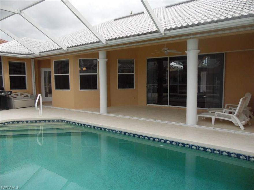 Location, location, location! This tropical 3/2 water front home is located just minutes away from Marco Islands pristine beach. Invite family and friends to this beautiful tropical getaway. Great rental potential for investors. Easy walking distance to shops, restaurants, Marco Movie Theater, and 3 blocks away from one of Marco Island's new Beach Access Points. Property features include: 3 spacious bedrooms, 2 bathrooms plus den, vaulted ceiling in family and dining room, 2 car garage with new epoxy floor, tile roof, screened lanai, heated pool, fenced and lighted dock, electric boat lift, fruit trees, multi-zoned automatic irrigation, freshly painted interior, new carpets, ceiling fans and located mid street on quiet cul-de sac. Master bedroom includes tray ceiling, fan, and sliding doors that go onto lanai. Master bathroom includes dual sinks, separate tub, large shower, large walk-in closet and separate linen closet. The property has been kept in excellent condition and the entire exterior of the home has recently been professionally painted. This unique find won't last!