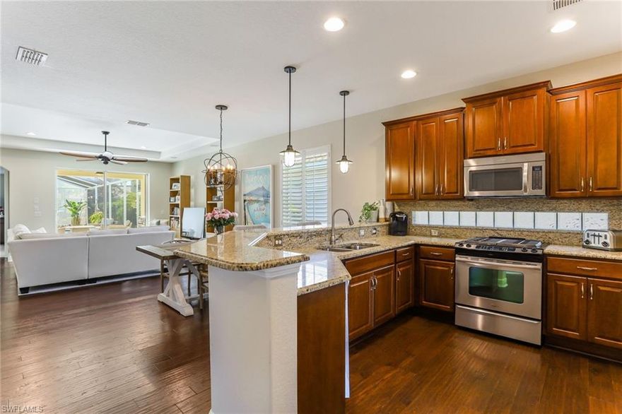 Prime Estero location for this spacious and well-appointed pool home featuring engineered wood floors throughout the living area. Kitchen has upgraded wood cabinetry, glass block backsplash, granite counter tops, Stainless Steel  appliances, walk in pantry and opens to a large dining area. First floor master suite features a walk in closet, master bath with granite duel vanity and separate tub and shower. Downstairs an additional guest bedroom/bath as well with added barn door for privacy. Upstairs you will find a spacious and separately temperature controlled flex/bonus room—perfect for a guest room, home office, or gym! Step outside onto the upgraded travertine tile to your private screened lanai with heated salt water pool. This stunning two story home offers quality through such as plantation shutters, custom wall trim work , designer fans and lighting, and upgraded cabinetry. Popular Gianna floor plan with extended 2 ft added to the garage and master bedroom! Surround Sound in bonus room, living, and lanai outside. The Reserve at Estero is a 24-hour guard gated community, with a Resort Style Pool with Spa, Pickleball, Basketball, Tennis, Fitness Room and much more.