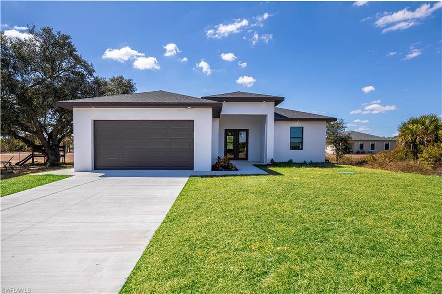 Stunning new construction in desirable Port LaBelle! This beautifully designed 3-bedroom, 2-bath home with a spacious 2-car garage offers the perfect blend of modern elegance and everyday comfort. Step inside to soaring vaulted ceilings and a bright, open-concept layout that feels both expansive and inviting. Gorgeous tile flooring flows seamlessly throughout the entire home, creating a clean and cohesive look.
The heart of the home is the stylish kitchen, featuring a large center island ideal for entertaining, meal prep, and gathering with family and friends. LED lighting throughout enhances the home’s modern appeal while providing energy efficiency.
Impact-resistant doors and windows offer added security and peace of mind. Step outside to the oversized lanai—perfect for enjoying Florida sunsets, outdoor dining, or creating your dream backyard oasis.
This exceptional Port LaBelle home combines quality craftsmanship, thoughtful design, and contemporary finishes—ready for you to move in and make it your own.