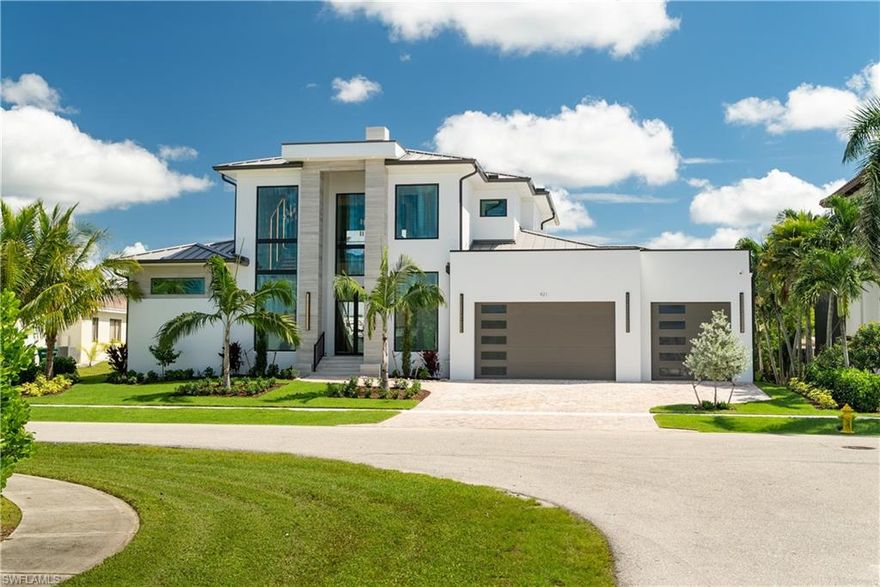 Welcome to 921 Giralda Ct — a striking contemporary new construction waterfront estate on Marco Island, offering 4,345 sqft under air, 5 ensuite bedrooms, 5.5 baths, and impeccable craftsmanship throughout. Perfectly situated in one of the island’s most coveted neighborhoods, this architectural showpiece combines sleek modern design with effortless coastal sophistication.

Step through the grand entry to soaring ceilings, floor-to-ceiling glass, and an open-concept layout that invites in natural light and showcases panoramic canal views. The gourmet kitchen is a true centerpiece — featuring top-of-the-line Wolf appliances, Sub-Zero refrigeration, custom cabinetry, quartz countertops, and an oversized island designed for gathering and entertaining.

Each bedroom serves as a private retreat, complete with its own ensuite bath and designer finishes. The luxe primary suite offers tranquil water views, a spa-inspired bathroom, and direct access to the lanai.

Thoughtfully designed for both comfort and convenience, the home includes a 3-stop elevator, laundry rooms on both the main and upper levels, and smart integrations throughout — ideal for families or guests.

Experience true indoor-outdoor living with a resort-style pool, integrated spa, outdoor kitchen, motorized bug screens, and shutters, along with a spacious covered lanai — perfect for sunset dining or lounging in the Florida breeze. With direct Gulf access, this home is ideal for boating enthusiasts.

Additional highlights include hurricane-impact glass, a whole house generator, a 3-car AC garage, and a prime location just minutes from world-class beaches, shopping, and dining.

Offered fully turnkey furnished, this residence is move-in or rental-ready — presenting an exceptional opportunity for investment or full-time island living.

Don’t miss your chance to own a modern waterfront masterpiece in paradise.