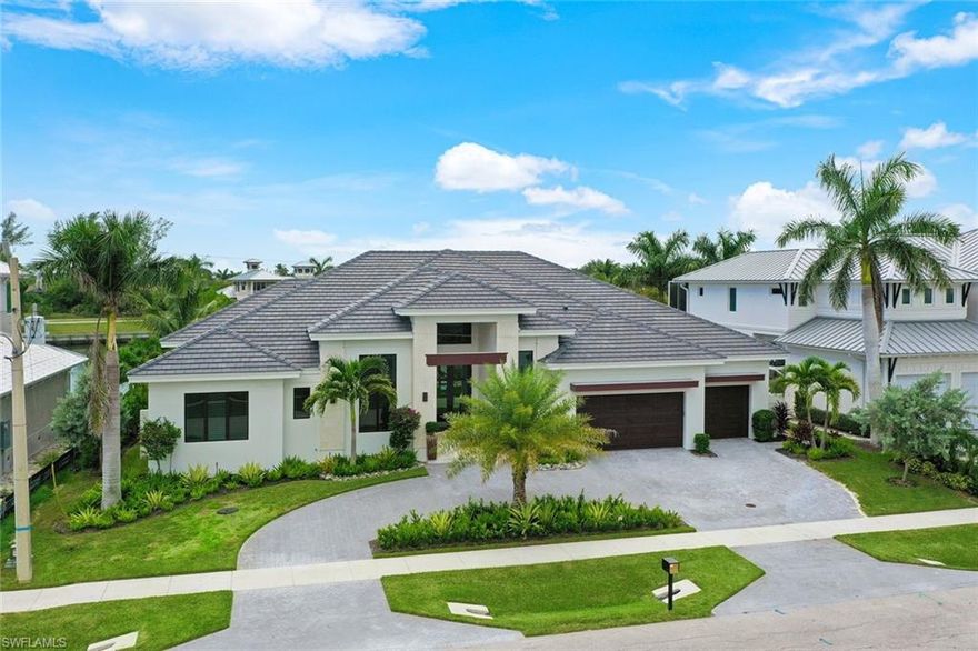 SIMPLY STUNNING! AVOID THE 2 YEAR WAIT FOR A NEW HOME... This Beauty was Custom designed to take in the beautiful wide water views and fabulous Marco sunsets! **Built by Aqua Custom Homes in 2022 **This home truly offers the BEST OF THE BEST! Great Room with 13 ft ceilings- ( linear AC vents) 10Ft sliders with 90 degree disappearing corner.. opens to a HUGE Lanai ( 25 x 25) You won't find this in most homes!! with fireplace, Gas Lanterns! outdoor kitchen and beautiful stained cypress ceiling detail.. complete with Roll down bug screens and Hurricane shutters to close in the space when needed. **PLENTY OF PREP SPACE . Kitchen with 12 ft long island- and beautiful stone countertop custom 4 FT GALLEY sink ( 2 faucets plus filtered drinking water ) 48'' WOLF gas pro range ( double ovens) 48'' pro SUB ZERO fridge- custom finished walk in pantry with ice maker and WOLF microwave. A Wine and Bourbon cellar with lighting, a dedicated cooling unit and remote operation. window shades are motorized for convenience- pool and spa equipment operated by either the Aqua Link or remotely via IAqua app. 2 Zoned AC units..