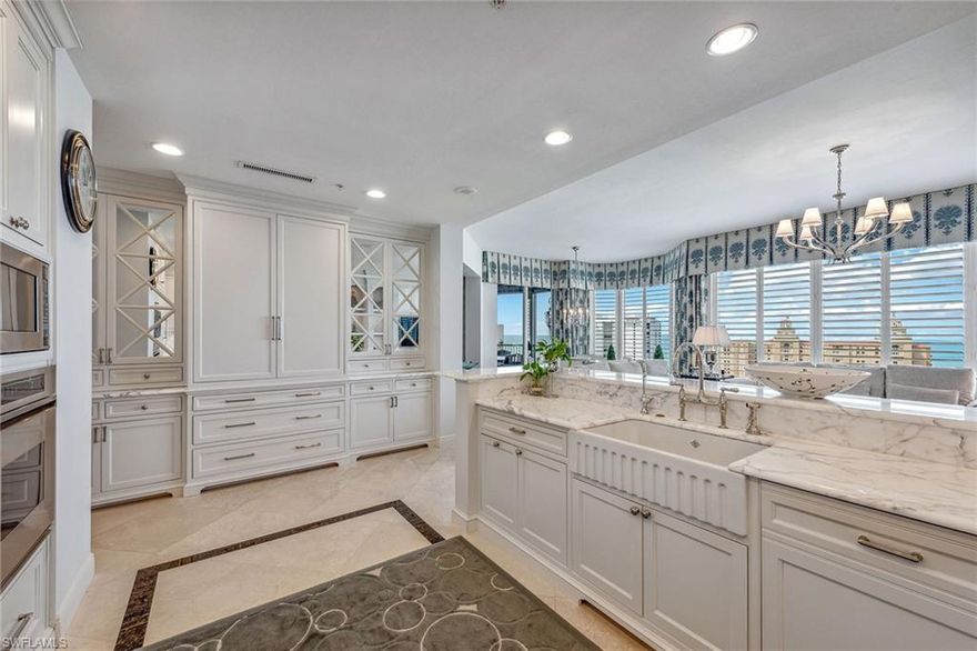 Fantastic high-floor views and soaring ten-foot ceilings greet you as you enter this professionally designed residence from your elegant private elevator foyer with over 4,100 square feet encompassing four bedrooms with a family room and four-and-a-half baths. The inviting great room features abundant space for casual living, dining, and outdoor entertaining options. The spectacular chef's kitchen features Carrara marble countertops, Sub-Zero refrigeration with two slide-out freezer drawers, a Wolf cooktop, finely crafted Shackleton cabinetry, designer lighting, and Baldwin door hardware throughout. Custom window treatments and wall coverings accentuate the designer appeal and attention to detail. Parking includes a private one-car garage and two additional under-building parking spaces. Trieste residents enjoy a resort-style pool with a private entertainment cabana, an updated social room, a fitness center, a lobby, a theater, and onsite guest suites. Bay Colony residents enjoy the private Beach Club with a restaurant, pool, bar, and fully attended beach services as well as tennis at the Bay Colony Tennis Club.