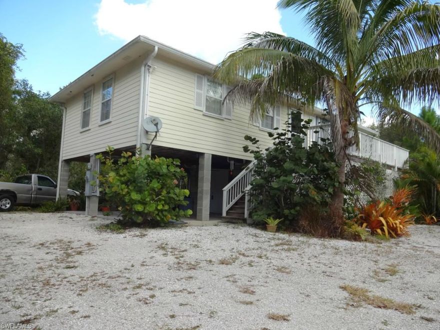 Come live the ultimate Florida lifestyle. This inviting home has all you need with plantation shutters, warm oak floors, 2 spacious bedrooms, inside laundry and great kitchen.  The 2 large deck areas (1 screened and 1 open) give you plenty of room to relax outside and enjoy the weather.  The home is sided in Hardy Plank, which is both low maintenance and attractive.  You will have plenty of room for storage with 2 extra rooms (one with a dehumidifier) located under the home, plus 2 covered parking spots, on a full concrete slab.  Along with extra parking for boats and toys, the lot has an over sized septic system.  Enjoy the fruit trees and lush tropical landscaping surrounding the home on it's double lot.  This home is located near Alden Pine Golf Course and Pineland Marina.  Pine island is known for its great fishing, Key West vibe and laid back attitude. Great local restaurants, fishing, kayaking and boating are what attracts people to the area. Take a look at this perfect getaway and fall in love.  Please see attached visual tour to appreciate this beautiful home.