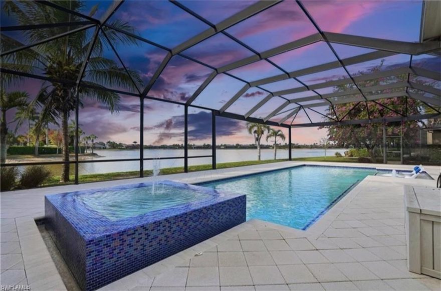 ONE OF THE BIGGEST LANAI'S AND ONE OF THE BEST VIEWS IN ALL OF NAPLES RESERVE! Enjoy entertaining family and friends in this masterpiece of contemporary design with 4 BRs and 3.5 BAs and a w-i-d-e lake view. This Ashton Woods Majorca model boasts a great room layout with 12' ceilings, accentuated by wall-to-wall dual open sliders that seamlessly integrate indoor and outdoor living spaces. Tile floors complement the contemporary aesthetic, while new modern designer ceiling fans and light fixtures add elegance. The kitchen is a chef's dreamscape, featuring Cucine cabinetry with upper and lower LED lighting, sleek quartz countertops, high-end stainless steel appliances, a precision induction cooktop with wall-mounted pasta pot filler, and a large 15' custom island! Additional amenities include a walk-in pantry, a wine bar, quartz counters, and a separate butler's pantry/food prep counter. Retreat to the spacious primary suite with his and her walk-in closets, beautiful lake views, and French doors leading to the screened lanai. The large spa-worthy primary bath boasts Cucine cabinetry, custom mirrors, upgraded tile floors, two separate vanities, and a walk-in shower. This home also features an en-suite VIP guest bedroom and two additional bedrooms connected by a Jack-n-Jill bath, providing ample space for family and guests alike—all generously sized. Step outside to your private paradise, offering a custom heated saltwater pool and spa with a 360-degree waterfall, both controlled remotely for convenience. The expansive screened lanai includes a state-of-the-art outdoor kitchen with a Twin Eagle Grill, ice maker, multi-drawer refrigerator, and a zero-clearance sink. The lanai is also enhanced with UV protection and an LED lighting system. Enjoy peace of mind with impact glass windows and doors, a security system, and the convenience of the central vacuum system. The laundry room is outfitted with custom cabinetry, a sink, and a hanging rack for convenience. Travel around in this family-friendly community in your golf cart and enjoy amenities that include a resort-style POOL, lap pool, DINING, dog parks, TENNIS, PICKLEBALL, children's PLAYGROUND, and more. You can add a dock and an EV boat to this dream home and enjoy the best and biggest lake that Naples Reserve offers. Don't miss the opportunity to own this spectacular coastal contemporary home, where every detail has been thoughtfully designed to create a luxurious and relaxing lifestyle. Experience the epitome of waterfront living today!