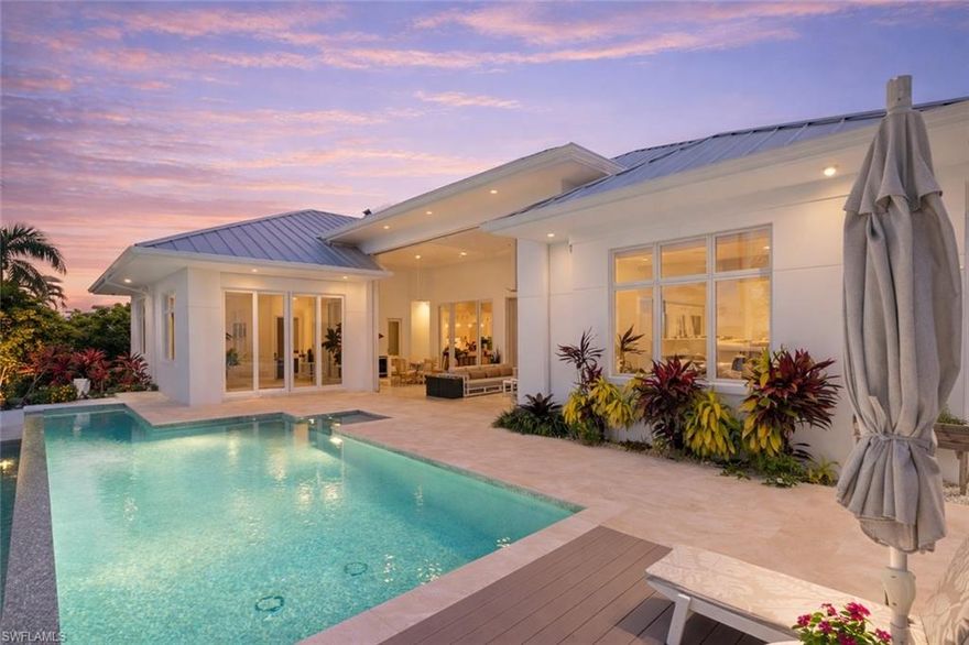 A thoughtfully designed waterfront residence created for comfortable everyday living and memorable entertaining. This like-new home offers 4 bedrooms plus a den, 3 full bathrooms, and a half bath, with a functional and flexible layout that easily adapts to a variety of lifestyles. The outdoor living space is a true highlight, featuring an infinity-edge lap pool, expansive composite decking, and a spacious covered lanai designed for year-round enjoyment. The fully equipped outdoor kitchen includes a Wolf grill, beverage refrigerator, and ice maker, while the adjacent den opens with sliding glass doors on two sides, creating an ideal space for relaxing or hosting guests. Boating enthusiasts will appreciate the private dock with a 14,000-lb lift and dedicated gear storage, making access to the water easy. Inside, the home is clean, refined, and filled with natural light, enhanced by an abundance of transom windows throughout. The kitchen is outfitted with Sub-Zero and Wolf appliances along with a wine refrigerator, and upgrades such as motorized shades add everyday convenience and comfort to the living spaces. The den offers flexibility as an additional living area, clubroom, or private office. Additional features include a 3-car garage with organized fishing gear closet, a fully decked attic for extra storage, and a portable generator. With direct Gulf access and no bridges, this property is ideal for boaters who want the convenience of being just minutes from the restaurants, shops, and vibrant lifestyle of downtown.