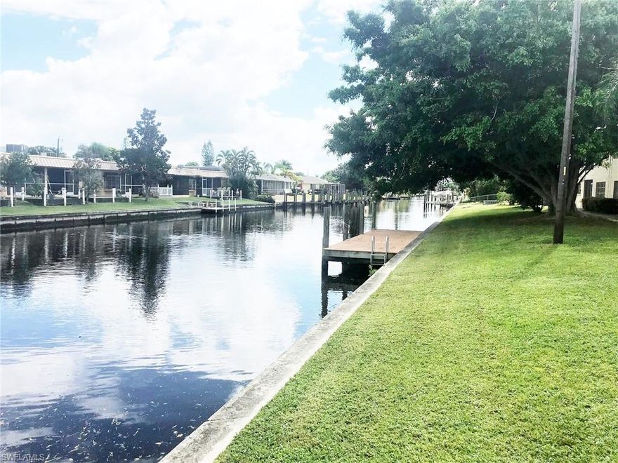 FIRST FLOOR GULF ACCESS CONDO perfectly located in SE Cape Coral with Assessments in & Paid! Only minutes to the River with no extra charge for community boat dock at your complex (first come first serve), plus fishing dock, exterior pest control, building insurance, community laundry, water, sewer, garbage removal plus close to beaches and The Yacht Club.  Nicely located downstairs corner unit with extra windows because you are on the end plus quick easy access to the parking lot and NO stairs to climb plus small sitting private screened patio. One of the most affordable complexes in SE Cape Coral. Newly resurfaced large community pool plus storage and bicycle area available. Within walking distance to dinning, entertainment, shopping and Cape Coral Parkway businesses. New Air Conditioning System. GREAT Investment rental since this prime location is always in demand and NOT age restricted.  Rare to find: assumable private mortgage. Do not let this one slip away.  You will not beat the price!