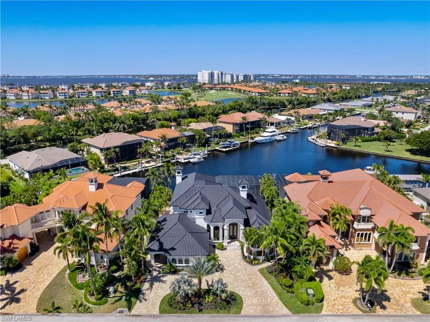 Experience unparalleled waterfront luxury in the prestigious deep-water boating community of Palmetto Point. This exquisite move-in ready residence has been completely reimagined, blending coastal contemporary elegance with upscale finishes and thoughtful design. Inside, an open floor plan with soaring ceilings and expansive windows fills the space with natural light, offering breathtaking views of intersecting canals and stunning western sunsets. The floating ceiling detail adds architectural interest, while light wood tones are beautifully balanced with deeper accents for a sophisticated aesthetic. The gourmet kitchen is a chef’s dream, featuring Wolf appliances, sleek countertops, and custom cabinetry. A temperature-controlled wine room provides the perfect space for collectors. Each of the four ensuite bedrooms offers comfort and privacy, while a media/billiards room ensures entertainment for all. Step outside to a resort-style outdoor living space, complete with wood beamed ceilings, built-in BBQ, two spas, and a large pool—all designed for ultimate relaxation. A concrete floating dock accommodates a 95’+ yacht, making this an exceptional retreat for boating enthusiasts. Additional features include a new roof, elevator, A/C workshop, and a three-car garage. This is truly waterfront living at its finest. Don’t miss your opportunity to own this extraordinary home in one of SWFL’s most coveted boating communities!