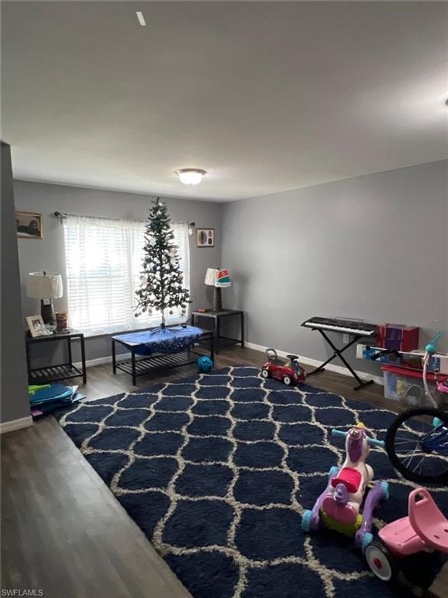 Discover your sanctuary in this beautifully appointed four-bedroom, two-bathroom home nestled within the charming embrace of Fort Myers. This thoughtfully designed residence beckons with its spacious layout and contemporary conveniences, perfect for families seeking both comfort and functionality.

The heart of this dwelling showcases an open-concept living area that seamlessly flows from room to room, creating an atmosphere of warmth and togetherness. Natural light cascades through well-positioned windows, illuminating every corner while highlighting the home's carefully crafted details. The primary bedroom serves as a peaceful retreat, offering ample space for relaxation and rejuvenation after busy days.

Your culinary adventures await in a kitchen designed for both everyday meals and entertaining guests. Two full bathrooms provide convenience for busy mornings and leisurely evenings alike, while three additional bedrooms offer flexibility for growing families, home offices, or guest accommodations.

Location enthusiasts will appreciate the neighborhood's tranquil residential character, where tree-lined streets and friendly neighbors create a genuine sense of community. The area provides convenient access to essential amenities, including nearby grocery shopping at Frank Cabrera Supermarket and quality education at East Lee County High School. For those seeking leisure activities, Golden Palms Luxury Motorcoach Resort adds recreational opportunities within the vicinity.

Commuters will value the property's strategic positioning with quick access to State Road 82, ensuring smooth connections to Fort Myers business districts, shopping centers, and entertainment venues. This location strikes an ideal balance between suburban serenity and urban accessibility.

The surrounding environment embraces Florida's natural beauty, where sunshine becomes your daily companion and outdoor living transforms from luxury to lifestyle. Whether you're beginning your homeownership journey or seeking your forever home, this property presents an exceptional opportunity to experience comfortable living in one of Fort Myers most desirable areas.