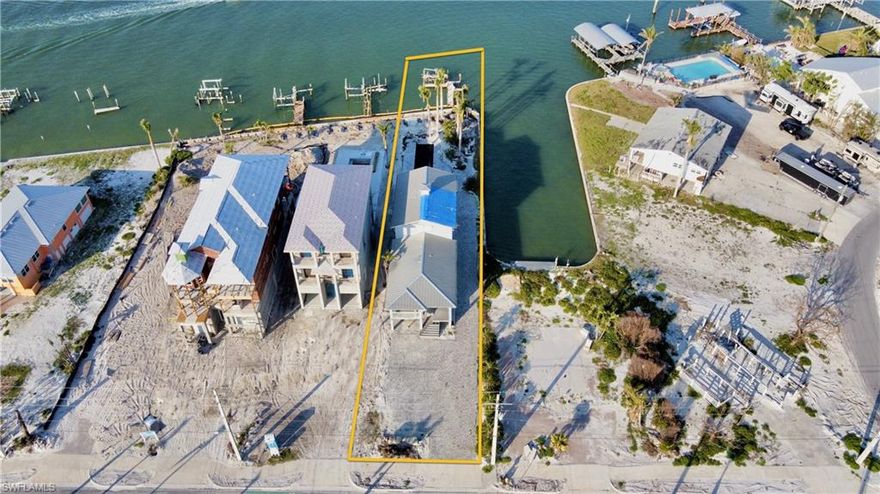 The Edge of the Water!  Rejuvenate this north end, Ft Myers Beach bayfront-beauty.  Structural Inspection completed on this multi-level single family home.  Breathtaking panoramic water views of the Estero Bay, no bridges out to the gulf, where environmental stewardship never goes out of style.   A short walk away from the soft white sands of the beach.   457 Estero Blvd offers over 200ft of wrap around seawall and just under on-third of an acre, paved driveway with ample parking areas. Rare opportunity to own one of the best bayfront locations where open-air spaces form an essential element of this 4-bedroom home. Destination found with this waterside serenity combined to invigorate a perfect balance between boating lifestyle and relaxation.  It emits a feeling that is simultaneously unassuming and ability to style to your own transformation adding finishing touches.  Seawall repair in place and under construction.   This is your year, your place in the sun and on the water.