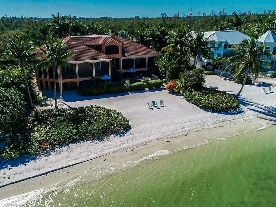 Enjoy serene and expansive water views from this stunning, 6000 sq ft, bayfront masterpiece with 125 feet of beach bay frontage! You’ll love the lights across the bay at night! Living is easy and all on one level with a 3 bedroom ensuite guest wing, a huge master suite at the opposite end and plenty of living and dining space in between. The impressive gourmet kitchen offers granite, marble, cork flooring, custom cabinetry and professional appliances. It’s open to the large, informal gathering area which features two corners, with pocketing, sliders, that open onto the lanai with outdoor kitchen, fireplace and spectacular bay views!  The formal living area has a voluminous coffered ceiling, imported stone fireplace and a big picture window over looking the waterfall, pool & bay.  The elevator quickly takes you from the garage to living area to the 3rd floor 9-seat, Moroccan-themed, theater.  Two separate garages will house 5-6 cars and all your water toys!  Most furnishings included.