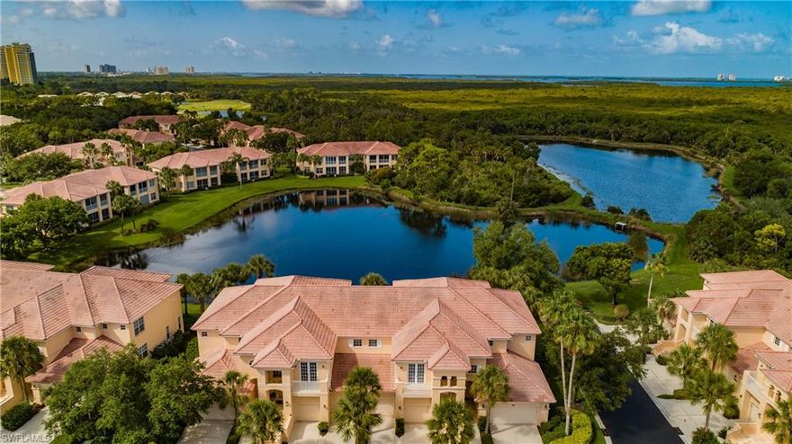 Just Reduced!!!!  Lowest priced large unit with a full water view. Located in West Bay Club, this rarely available 2nd floor condo with the most prized view across two lakes and into the natural preserve is now on the market.  just over 2,800 sq. ft, 3 bedroom, 3 bath, tile throughout the main living area, freshly painted, granite in the kitchen, New carpet for bedrooms 1, 3 and stairs to be installed.   Tile just installed in master bath, wind rated sliding doors enclosing the air conditioned sun room adds approximately 200 sq.ft. of living area, elevator from the garage level, built in cabinetry in the den and second bedroom in addition updated appliances and completely renovated elevator system. Amenities at West Bay Club include a recently redone 18-hole championship golf course designed by Pete and PB Dye, private beach club with dining on the Gulf of Mexico, boat launch at the River Park, common area boat storage, kayak and canoe park, dog park, new pickle ball and bocce park, playground, basketball court, Jr-Sized Olympic pool, fitness center, tennis Har-Tru courts.  The Golf Club and course are by private membership, social memberships available for non golfers.