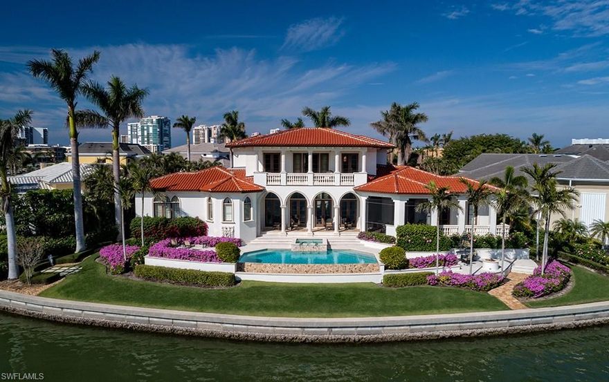 This comfortable, yet elegant, masterpiece built by Kurtz Homes Naples, situated along 172 feet of water frontage (as per plat), offers sweeping views of Moorings Bay. A large grand salon encompassing the formal living and dining spaces harmoniously opens to the covered terrace and pool deck beyond. The well appointed kitchen with large island and adjacent family room were well executed to become a more intimate gathering area for casual entertaining. A first floor master suite and a second floor master suite, each with their own offices, in addition to two more guest suites, ensure privacy for the owners and guests alike. Conveniently located in The Moorings, situated on a cul-de-sac location, and in close proximity to the beaches of Naples and Village at Venetian Bay, this is a very unique offering.