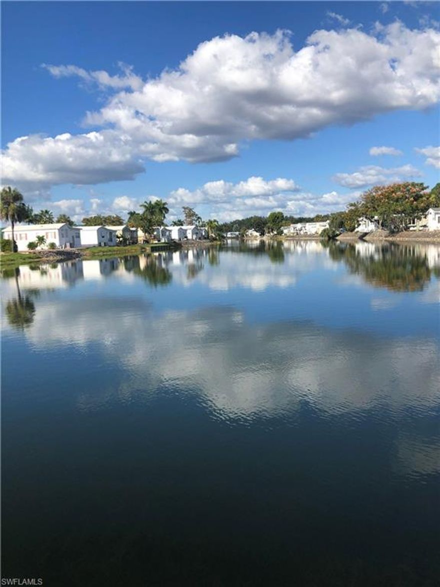 You are going to LOVE the beachy décor and the comfortable, homey feeling when you enter this house.  It is located at the end of the "little" lake so you have an unbelievable water view with a nice lake breeze.  The back patio has been turned into your own little, private cabana where you can sit with your morning coffee and watch the sun rise to your right.  It also offers a cute little sitting area just outside of the entry door. The trees in front of the home offer privacy.  The home also offers a nice, roomy entry with a storage closet that features a stackable washer/dryer combo.  Both inside and outside have ample storage areas.  It has a brand new 3 ton Rheem air conditioner.  It has two new awnings, 4 y/o water heater, Pergo flooring, new carpet in den, and much more.