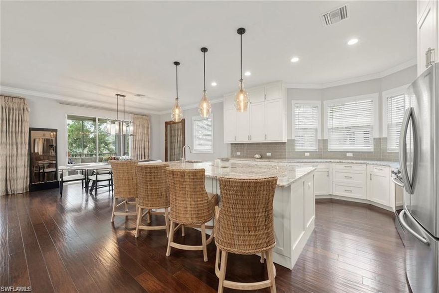 Annual rental available furnished or unfurnished! Fully renovated top-floor coach home in the gated enclave of Vintage Reserve at The Vineyards, offering over 2,300 square feet and living like a single-family residence with a wide-open, modern floor plan. This beautifully reimagined property features a stunning kitchen with white cabinetry, stainless steel appliances, sleek countertops, an oversized island with seating, and a built-in beverage cooler, seamlessly flowing into the dining and great room—ideal for entertaining and everyday living. With 3 bedrooms plus a private den and 3 full bathrooms, the layout provides exceptional flexibility for guests, or remote work. Soaring ceilings, abundant natural light, rich wood flooring, and refined finishes create a bright, airy ambiance throughout. Enjoy top-floor privacy with both the great room and primary suite opening to a spacious screened lanai overlooking a tranquil preserve with no neighboring buildings in view. The primary suite offers a custom walk-in closet and a spa-inspired bath with dual vanities and a walk-in shower, while a dedicated office with board-and-batten detailing adds charm and functionality. Additional highlights include a 2-car garage with brand-new epoxy flooring.  The Vineyards is just minutes from Naples beaches, Mercato, Waterside Shops, and 5th Avenue South—making this move-in-ready home a rare opportunity for space, privacy, and modern Naples living.