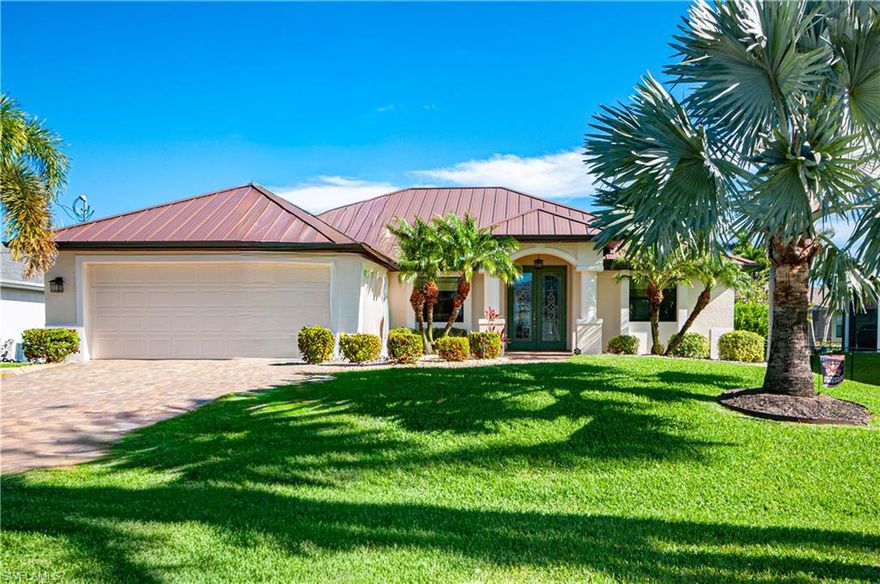 Beautiful southwest pool home on a royal palm–lined street, located across from stunning waterfront residences in the desirable Agualinda Boulevard & Beach Parkway neighborhood (Southwest quadrant). This meticulously maintained residence offers 3 bedrooms, 2.5 bathrooms and a thoughtful indoor/outdoor floor plan.
Enter through the 8-foot entry door to an open living area with tray ceilings and abundant natural light. The kitchen features granite countertops and stainless steel appliances and flows to the living and pool areas — ideal for entertaining. The primary suite opens via sliders to the pool patio and includes a bathroom with dual sinks and a glass-enclosed shower. A convenient half bath serves as a pool bath with direct access to the pool area. Additional interior amenities include an indoor laundry room.
Outdoor living is exceptional with mature tropical landscaping, a private pool and paver patio, and a paver driveway. Notable updates and features: metal roof, gutters and solar pool-heating panels (2023); fresh interior & exterior paint (Feb 2026); new hot water heater, washer and dryer (Sept 2025); impact windows and doors. The home has not flooded during past hurricanes and carries transferable flood insurance.