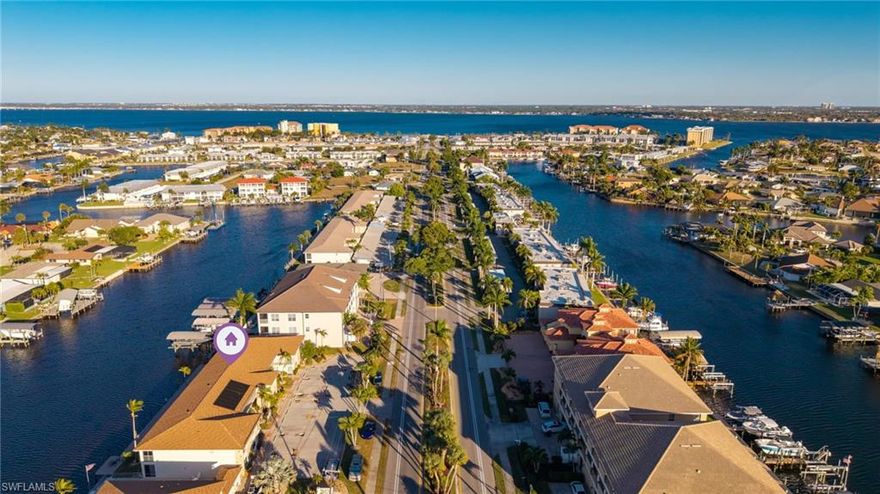 This charming two-bedroom condo, ideally located in the sought-after Beach Parkway area, is priced to sell and offers stunning Gulf views from the living room, where you can relax and watch dolphins play amid the surrounding natural beauty. Situated on a direct access canal with no bridges to the gulf, this property delivers exceptional waterfront living. Freshly painted and filled with natural light, the spacious living area offers picturesque water views and flows seamlessly into a cozy side dining space. The split floor plan provides privacy at each end of the home, making it perfect for guests or family. The quaint kitchen offers ample storage for all your needs. The spacious primary bedroom features serene water views and an en-suite bath with dual sinks. Step out onto the screened-in porch to enjoy cool coastal breezes and peaceful water views—an ideal spot to unwind. Recent updates include a newer roof and the community boasts a well-maintained pool and beautifully kept grounds. Owner will have one reserved covered parking space. Whether you’re looking for a full-time residence or a vacation retreat, this bright and airy condo is the perfect place to enjoy the sunny, warm Southwest Florida lifestyle. Located just minutes from the newly renovated Jaycee Park, soon to feature beach volleyball, a splash pad, a food truck park, and more. Schedule your showing today and don’t miss this fantastic opportunity!