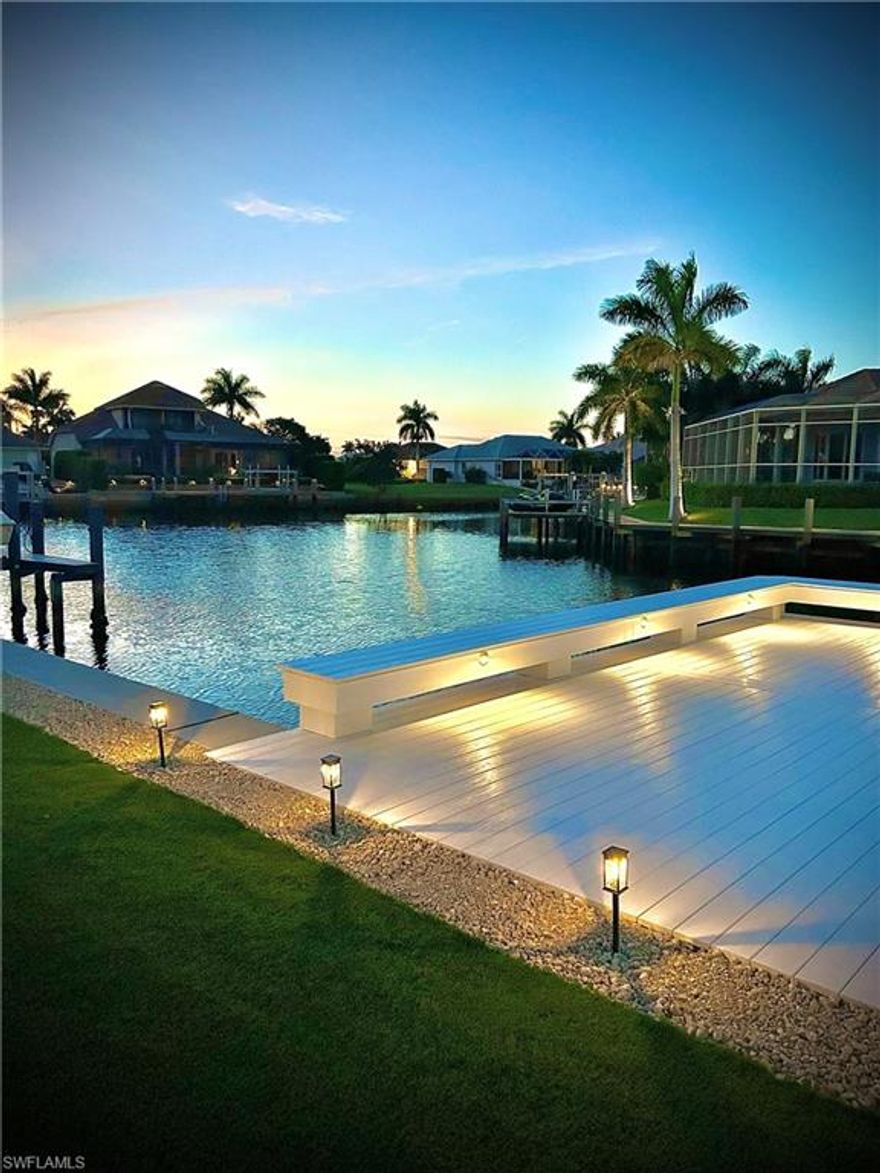 Experience true Marco Island living in this beautifully updated waterfront home, offering modern upgrades, expansive outdoor space, and stunning wide water views. Situated at the end of a quiet cul-de-sac, the property features a brand-new 111-foot seawall with a 25-year transferable warranty, along with a custom-built 800+ sq ft dock accommodating up to a 32-foot boat. A new 16,000 lb boat lift is also included, all with transferable warranties—perfect for boating enthusiasts. The home boasts a spacious, light-filled interior with fully retractable patio doors that seamlessly blend indoor and outdoor living. The large screened-in pool area with covered panoramic enclosure provides the ideal setting for relaxing or entertaining while enjoying serene water views. The modern kitchen is equipped with sleek cabinetry, black granite countertops, built-in oven and cooktop, and high-end appliances, including a Bosch integrated, ultra-quiet dishwasher. The dining area is perfectly positioned to take full advantage of the waterfront scenery. All bedrooms are generously sized with large windows that fill the space with natural light, many offering water views. The primary suite features a luxurious bathroom with a double walk-in shower with multiple shower heads, soaking tub, dual vanities, and contemporary finishes, along with a dedicated dressing area. The guest bathroom has also been tastefully updated. Additional upgrades include impact-rated Low-E windows (2021), a new roof and gutters (2018), new pool, deck, and lanai (2019), multi-split A/C system (2023), water heater (2020), pool heater (2025), and a newly paved driveway and patio (2026). The two-car garage includes a large hidden storage area behind stylish barn doors. This exceptional property combines modern comfort, quality upgrades, and prime waterfront living in one of Southwest Florida’s most desirable locations.
