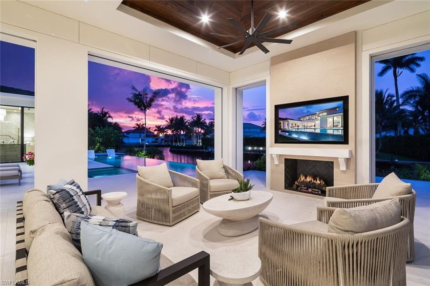 Showcasing light and breezy seaside-inspired aesthetics complemented by warm natural wood tones, this newly constructed masterpiece by Wilbrett Construction Company is a testament to exceptional craftsmanship.  Designed with sophistication by Kukk Architecture and finished with the exquisite touches of Freestyle Interiors, this home spans approximately 6585 square feet of meticulously planned living space, adorned with luxury features at every turn.  Step into a grand great room where intricate ceiling details add a touch of artistry and seamlessly flow into the chef's kitchen complete with custom cabinetry and a well-appointed butler's pantry.  Adjacent to this central space, a wet bar and temperature controlled wine cellar perfectly complement a spacious study, offering a refined retreat with custom cabinetry that harmonizes functionality and elegance.  The main-floor primary suite offers tranquil water views and a spa-inspired bath featuring a freestanding soaking tub and a walk-in shower.  Upstairs, four generously sized ensuite bedrooms encircle a central living area, which includes a wet bar and access to an extended balcony that captures spectacular wide water vistas.  Outdoor living is a dream come true with a resort-style infinity-edge pool, soothing spa, and sun shelf, surrounded by a covered loggia outfitted with remote controlled screens and shutters.  A stone-clad fireplace creates a cozy ambiance, while the outdoor kitchen makes hosting gatherings effortless and enjoyable. Ideally situated on the waters of Egret Channel, with its prime location at the intersection of Heron Cove and Gull Cove, the property takes full advantage of sweeping water views.  Boating enthusiasts will appreciate the deep-and wide water frontage, ideal for navigable access.  This serene setting is also just moments from Naples' pristine white sandy beaches and the shops and restaurants of Third Street south.  This thoughtfully designed residence embodies the quintessential Florida lifestyle, offering a rare blend of elegance, comfort, and functionality.