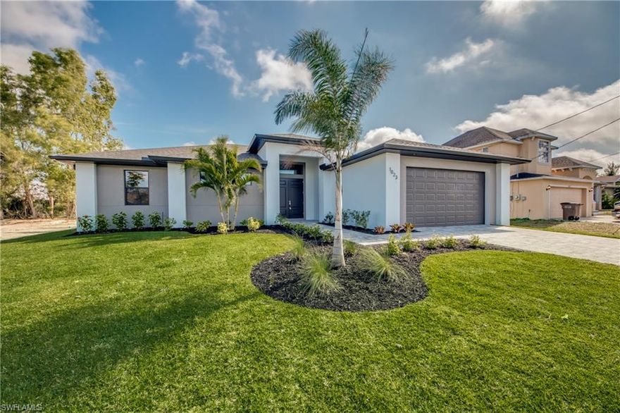 NEW CONSTRUCTION - TO BE COMPLETED END OF OCTOBER This 4 Bedroom, 3 Bath, 2 Car Garage home comes with all the Bells and Whistles. Home is 2,010 sq ft under air with a total of 3,998 sq ft when you include your 1,402 sq ft lanai with an oversized pool and located on a freshwater canal! The Kitchen has been decked out with 42" All Wood Cabinets, Stainless Steel Appliances, Granite Countertops, and a huge Kitchen Island. Designer plank tile flooring installed throughout all the living areas. This home has a Paver driveway, Paver pool deck, complete landscape package with sprinkler system and flora tan sod. The interior specs are 12’ Ceiling in living area, 8' doors, 5 1/4" Baseboard with 3 1/4" Casings, Soffit lighting outside, Frameless Glass Shower Enclosure, Stand Alone tub in the master bath, Trey Ceilings in the living room and master bedroom, pendant lighting in the kitchen, pool bath and so much more. This home is located in the desirable SW section of Cape Coral and comes with a 1 year builder warranty