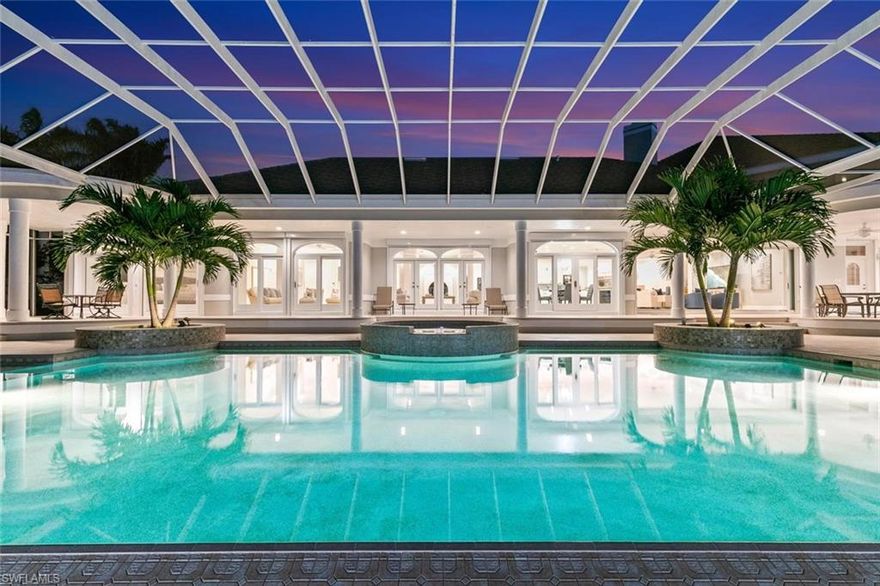 Are you dreaming of sunsets in paradise? Look no further! This beautiful Marco Island waterfront home boasts expansive views of Caxambas Pass. It has everything you could possibly want, including 241 feet of waterfront dockage for a 100+ foot yacht, a boat/tender for the yacht, and 2 jet skis all at the same time while maintaining an unobstructed view! Entertaining is a must in this gourmet kitchen complete with a gas cooktop; a beverage center on the kitchen island; a floor-to-ceiling, double-door wine cooler; and 2 ice makers. The kitchen overflows into the spacious living room and lanai to enjoy the free dolphin shows. Other interior features include: central air with UV filters (each of the 4 units has its own UV filter); a central vacuum system on the main floor, 2 gas fireplaces, a steam room; second-floor impact windows and sliding glass doors; and, the home is elevator ready!! There are TWO master bedrooms (one on the main floor and the second master is upstairs).  Did we mention every single bedroom has a balcony overlooking the water? The second-floor living area and master bedroom have mini-fridges, microwaves, and sinks. Cars, and other motorized toys, are a must for this home where you have an oversized 3-car garage, circular driveway, and portico! This beauty is only minutes to open water and yet tucked in for storm protection. You won't find another property like this on the market today!