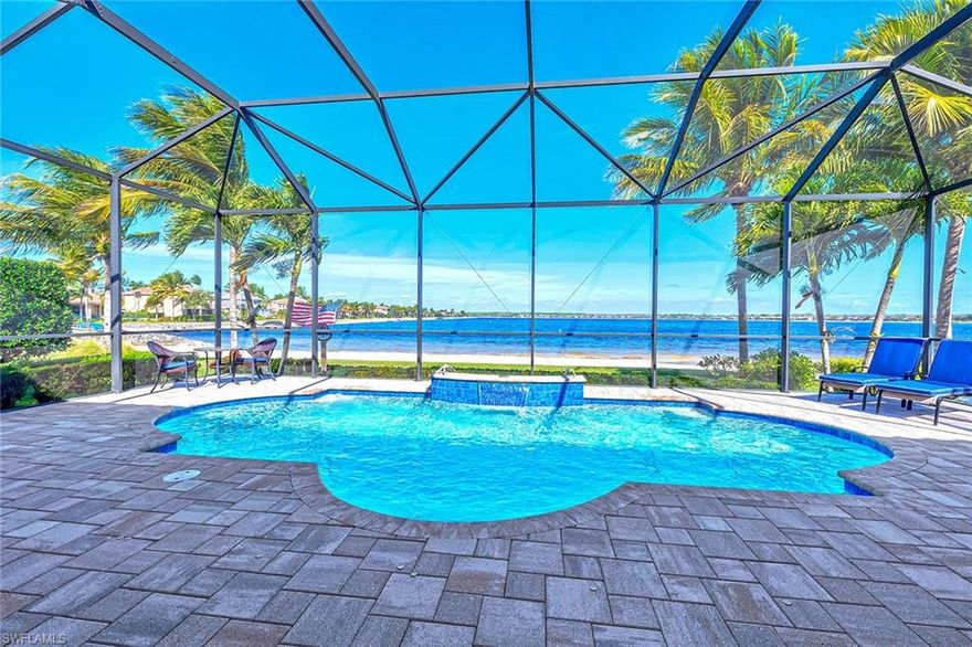 Experience the ultimate Naples resort lifestyle at 9087 Breakwater Drive, located within the prestigious QUARRY community with a DEEDED BOAT DOCK included!  Situated on a private, brick-paved street inside this gated enclave, this exceptional largest LAKE FRONT in Collier County residence.  Offering both privacy and unparalleled access to world-class amenities.

This stunning two-story home overlooks Stone Lake—the largest and deepest lake in Collier County—framed by swaying palm trees and a rare sandy beach that stretches along the entire northern perimeter of the property. Enjoy breathtaking water views and direct access to recreational boating, fishing, kayaking, and water-skiing, with a deeded private boat slip just steps away in an exclusive neighborhood marina.

Designed for comfort and flexibility, the home features 5 bedrooms plus a den/library and 4.5 bathrooms. The primary suite and three additional bedrooms are conveniently located on the first floor, while the second level offers a versatile fifth bedroom currently configured as dual offices, easily adaptable into a guest suite, game room, lounge, or nanny suite with a full bath and walk-in closet.

The open-concept kitchen, dining area, and great room are ideal for both everyday living and entertaining. Highlights include KitchenAid appliances, a 36" electric cooktop, oversized walk-in pantry, indirect ceiling lighting, built-in speakers, and expansive sliding glass doors that seamlessly connect indoor and outdoor spaces. Hurricane-impact doors and windows provide peace of mind throughout the home.

Step outside to the screened lanai, where a saltwater pool with waterfall, covered entertaining area, built-in cabinetry, quartzite countertops, stainless steel sink, electric fireplace, beverage refrigerator, outdoor TV hookup, and speakers create the perfect setting to relax and take in the serene lake views.

Additional features include a 30’ x 30’ three-car garage with porcelain tile flooring, LED lighting, custom cabinetry, stainless steel utility sink, and dedicated 20-amp outlets for power tools. The home also offers an expansive attic with standing-height storage, painted plywood flooring, LED lighting, and Icynene foam insulation.

As a Quarry homeowner, enjoy full access to the Beach Club amenities, just a short walk away—tennis, pickleball, bocce, resort and lap pools, hot tub, poolside showers, lakefront dining, tiki bar, and a state-of-the-art wellness center featuring a fitness gym, activity rooms, card room, lending library, and physical therapy center.

This is more than a home—it’s a lifestyle defined by luxury, recreation, and natural beauty.