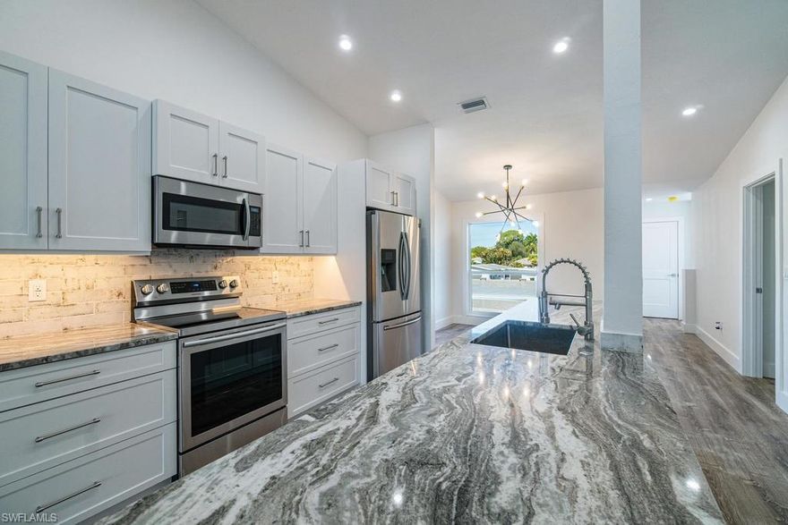 C.17159 - Remodeled from the front to the back and it’s just like a brand new condo! Skip the trouble of a lengthy remodel...this one is move-in ready. This open floor plan boasts a contemporary coastal look graces this condo from the neutral LVT wood floors, contemporary white cabinets throughout, sandy granite countertops, stainless appliances, newer HVAC, new lighting, impact glass windows, built-in electric fireplace and rolldown shutters on the lanai. Relaxing on the roomy lanai with friends and enjoy the park-like setting. Best of all is the location. Walk to shops & restaurants at the Pavilion & Mercato, the library, a community park, and the spectacular beaches! Pavilion Club is a great place to call home even if it's just for the Winter season. Buildings have new paint & new awnings in the works. New carports were installed in 2019.