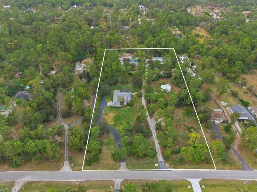 Exceptional opportunity to own 5 acres in Golden Gate Estates with a main home, guest house, and 3 additional buildings.  This is the ideal property for a small business owner in need of storage space for equipment and work vehicles, a car collector, or anyone in search of a home with much privacy.  The main home features 3 bedrooms plus a den, 2 baths, a light and bright interior, and new roof in 2022.  The newly remodeled kitchen features white cabinetry, white counters, stainless appliances, coffee bar with wine cooler, and a large center island.  The master suite is a private retreat with ensuite bath with dual vanities, jetted tub, and walk-in shower.  The interior of the home opens to the spacious screened lanai with large pool.  This is the perfect place to relax poolside while entertaining friends and family.  The newly constructed guest house (2019) boasts bedroom plus den, bath, fully equipped kitchen with gorgeous finishes, and a screened lanai.  Enjoy peace of mind with generators for both homes each with 500 gallon propane tanks.  With 3 outbuildings and additional carport, this home offers unlimited potential.  2 of the outbuildings feature electric service.  The grounds feature beautiful natural Florida flora and fauna, creating a tranquil private atmosphere.  Enjoy all this while being just minutes to all that Naples has to offer.  Do not hesitate to make this rarely available 5 acre estate your peaceful sanctuary.